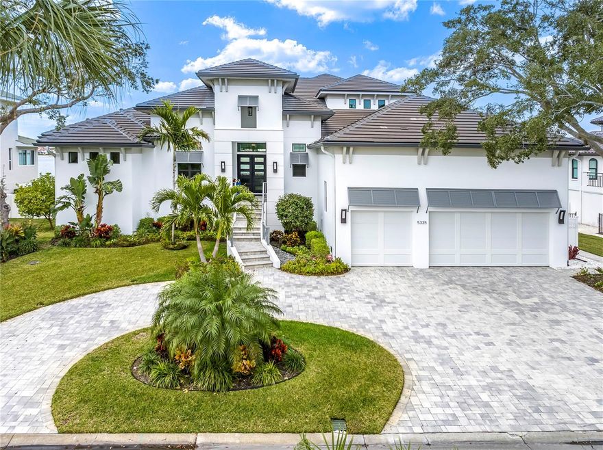 Discover unparalleled luxury in this coastal contemporary waterfront masterpiece. Prepare to be captivated as you enter through exquisite iron and glass custom double doors, offering a seamless transition from the entry to an expansive view of the sleek infinity pool and tranquil waters beyond, creating a harmonious blend of luxury and nature. The interior boasts an open floor plan, emphasizing spaciousness and natural light. High-end finishes, smart home technology, sound system and sustainable design elements contribute to the overall sophistication of the residence. Dive into the Florida lifestyle with your private boat dock, with 40+ ft water slip, lift, electric & water utilities. First floor is designed for luxurious living with endless water views. Expansive rooms with walls of breakaway sliders allowing natural light and fresh air to fill the rooms. Great room exudes warmth from wall to ceiling stone fireplace and ceiling beams, complemented by a convenient wine bar.  Gourmet kitchen is a culinary enthusiast's dream, equipped with double islands, high-end appliances and oversized walk-in pantry. Den offers a versatile space for relaxation or entertainment, complete with full wet bar. Home office provides a dedicated workspace for productivity located to the front of the house. Primary suite is strategically positioned to capture breathtaking waterfront views. The suite itself is a haven of comfort and sophistication, offering direct access to an outdoor fireplace and seating near the pool. With meticulous attention to detail, the primary suite seamlessly integrates indoor and outdoor living, creating a retreat that combines elegance with the refreshing ambiance of the infinity pool and scenic surroundings. Additional guest bedroom ensuite located on the 1st floor provides flexibility for hosting visitors, ensuring a perfect balance of comfort and convenience.  Ascend the stairs to discover an expansive game room with wet bar, offering a dynamic space with a focus on entertainment and relaxation.  Additional 2 large bedrooms and baths. Balcony serves as an inviting extension, allowing occupants to bask in the outdoor ambiance while indulging in indoor recreation. It's a perfect blend of entertainment and scenic tranquility, making this game room a captivating retreat. Home boasts an oversized 3-car garage, with more than ample space! Tons of storage space extending under the home. Custom lift for groceries, luggage or wheelchair access. Ask about the details. Full home generator.  Custom built with attention to every detail. Located in Bayway Isles, a guard-gated island community.  Characterized by luxury waterfront homes, this enclave exudes a sense of privacy and security. Residents enjoy proximity to Fort DeSoto, PassAGrill and St Pete beaches, and the convenience of being just a short drive from the vibrant cultural scene and amenities of downtown St. Petersburg. Bayway Isles combines the tranquility of an island retreat with the allure of coastal living, making it an ideal haven for those seeking both relaxation and urban convenience. Bedroom Closet Type: Walk-in Closet (Primary Bedroom).