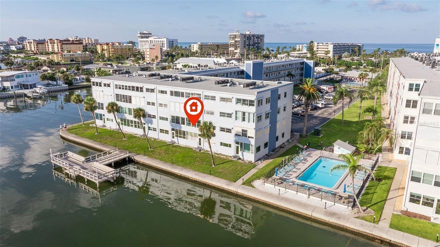 Direct Waterfront Living Across the Street from the Award Winning St Pete Beach!  Live everyday like you are on Vacation living in this centrally located property on Gulf Blvd.  Walk to the Beach, Restaurants, Beach Bars, Shopping, Local Events and More!   Amazing, Unobstructed Boca Ciega Views from your Sunroom and Primary Bedroom!  Split Bedroom plan, both with Walk-In Closets. This unit has Hurricane Impact Windows, New HVAC System and New Electrical Panel.  Reserved Parking ad Guest Spots.  Don't miss out on this opportunity to make this Condo Your OWN!  This property was water damaged by Milton from the Roof.  Remediation was done down to the Studs, new Drywall was installed giving the right buyer the opportunity to select all of the finishes!  The Community boasts Resort-like Living with A Clubhouse, Two Pools, Fitness Center, Shuffleboard, Picnic Area, Fishing Dock, Laundry Facilities, Elevators and Additional Storage.  The possibilities are endless!