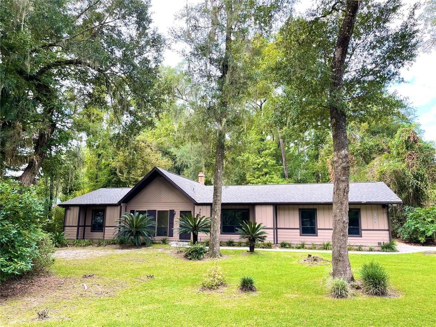 Welcome to this beautiful, fully-renovated, 1-story, nearly 1,800 SF, 3 BR, 2 Bath, indoor utility room, oversized 2-Car Garage, Ranch home nestled in the desirable Rock Creek community of northwest Gainesville off of 34th street. Rock Creek is an established, highly sought after neighborhood featuring canopies of age-old oak trees, beautiful winding roads and local wildlife. This unique home is situated on over one third of an acre, on a corner lot, and has a fully-fenced large back yard for outdoor barbecues and entertaining with family & friends. Enjoy a split, open floor plan with tremendous natural light, high vaulted ceilings, a dedicated wet bar and a stunning floor to ceiling brick fireplace at the heart of the home for all to enjoy. Cooking in this new galley kitchen will not disappoint with all new cabinets, new butcher block counters, marble backsplashes, new lights & light fixtures and much more. Both the breakfast nook and kitchen sink overlook the beautiful back yard. This home has a newer roof (2022), a brand new HVAC unit (2023), new Luxury Vinyl Plank flooring throughout, New Kitchen, New Bathrooms, all New Interior Paint, New LED lights, New toilets, New fixtures and the list goes on. Prepare to feel like you are “home” when you walk in the door to the combined formal dining and family rooms overlooking the gorgeous fireplace. Enjoy the amazing amenities that Rock Creek has to offer including keyless entry to: pool, tennis courts, pickleball courts, basketball court & playground all included in the low HOA fee. Also enjoy the convenience of living less than 4 miles away from the University of Florida where you may or may not attend but can really enjoy being a spectator of incredible college sports! Come see what could be your Home!!!