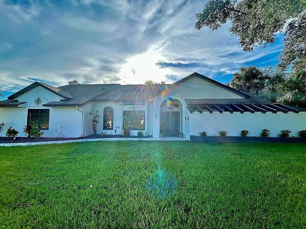Experience the ultimate Florida lifestyle in this beautifully updated 3-bedroom, 2-bath home located in desirable Punta Gorda. Spanning 2,700 sq ft of open, light-filled living space, this home sits on a generous ½-acre lot and offers a host of upgrades for comfort and style. The fully remodeled main bathroom, new roof, and freshly painted interior and exterior are just the beginning. The spacious kitchen features a wine bar and a convenient hall pantry, while the pass-through window and French doors provide easy access to the expansive outdoor living areas. Relax or entertain in the 40’ x 16’ heated saltwater pool with inground spa, or enjoy evenings around the new fire pit with seashell rock surround. A massive screened lanai with a custom 12’ snack bar adds to the outdoor appeal, perfect for hosting guests. Inside, the home features no carpet—only tile and luxury vinyl plank flooring throughout. Additional highlights include a working natural fireplace, transom and Palladian windows for natural light, and ample storage space throughout the home and garage. The garage also offers a work area, whole-house generator, and an extra fridge. With everything from outdoor living to modern updates, this home is perfect for both relaxation and entertaining.
