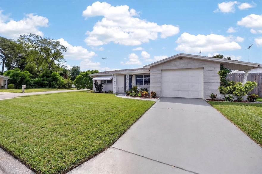 One or more photo(s) has been virtually staged. Corner lot living with a modern touch—welcome to this well-maintained 3-bedroom, 2-bathroom home in Port Richey. This property features a functional layout with comfortable living spaces, a 1-car garage, and great outdoor potential.

The updated kitchen offers a clean, modern feel with white shaker-style cabinetry, sleek countertops, and stainless steel appliances. Ample cabinet and counter space provide both functionality and style, while the window over the sink allows for great natural light. The kitchen flows seamlessly into the main living area, creating an open and inviting space.

The home also features a newer roof providing added peace of mind for years to come. The fully fenced backyard is perfect for pets, outdoor entertaining, or simply enjoying your own private space.

Conveniently located near shopping, dining, parks, and major roadways, and just a short distance from Werner-Boyce Salt Springs State Park, where you can enjoy kayaking, hiking trails, and wildlife viewing, this home offers both comfort and accessibility.