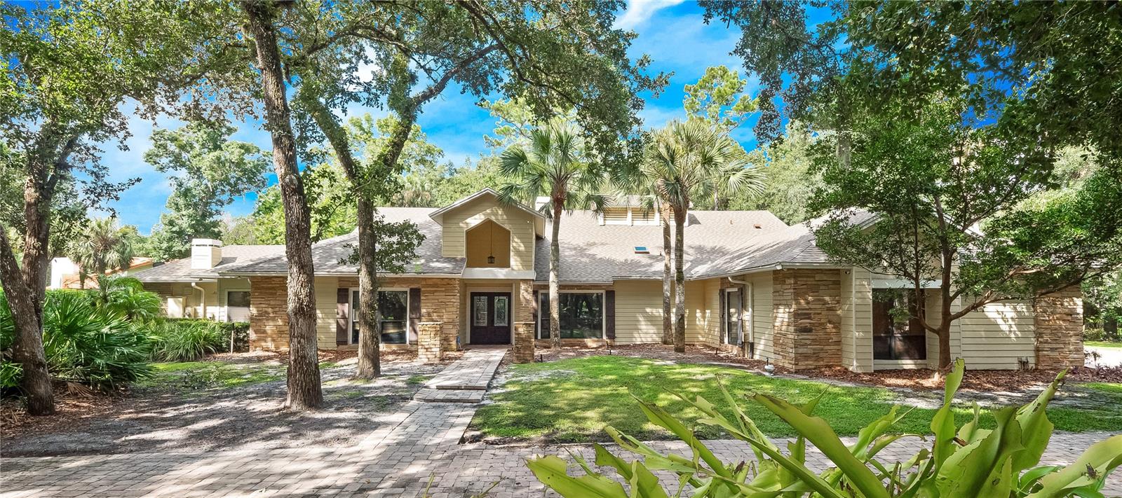 Timeless Elegance Meets Resort-Style Living in Wingfield Reserve. Nestled on a beautifully manicured 1+ acre corner lot in the exclusive Wingfield Reserve, this single-story estate offers the perfect blend of traditional elegance and modern luxury. Boasting 5 spacious bedrooms, 3.5 bathrooms, and over 4,900 square feet of living space, this meticulously maintained pool home is an entertainer’s dream and a true sanctuary. Step inside to soaring cathedral ceilings and wood-look tile flooring that flows seamlessly throughout the home. The open-concept layout delivers both privacy and connectivity, ideal for everyday living and large-scale entertaining. The chef’s kitchen is a culinary masterpiece, featuring rich wood cabinetry, granite countertops, and a Tuscan-inspired stone backsplash framing a gas range that anchors the space in warmth and sophistication. Retreat to the expansive primary suite, complete with a private sitting area, sliding glass doors to the pool area, and a luxurious en-suite bath featuring dual vanities, a spa-like soaking tub, and a separate walk-in shower. The custom California closet conveniently connects to the laundry room for added functionality. Each of the guest bedrooms is oversized and includes a walk-in closet with custom organizers. Two of the bedrooms are connected by a Jack and Jill bathroom, perfect for family or guests. Oh and did I mention, NEWER ROOF (2019), and one NEW HVAC & WATER HEATER (2024). WOW! MASSIVE THREE CAR GARAGE for all of your cars and toys! But the true showstopper? Step outside to your private indoor paradise, an Olympic-inspired enclosed swimming pool beneath a stunning cedar roof, offering year-round enjoyment. Adjacent, a spacious Florida room with a wet bar sets the stage for unforgettable gatherings. The property also features a basketball court, gazebo already plumbed for an outdoor kitchen, and a dedicated storage room for tools and toys. Come see this majestic home before it is too late! Located minutes from top-rated Seminole County Schools, I-4, Lake Mary Blvd, SR 434, and the Seminole Wekiva Trail, this estate offers not just a home, but a lifestyle. Schedule your private tour, TODAY!