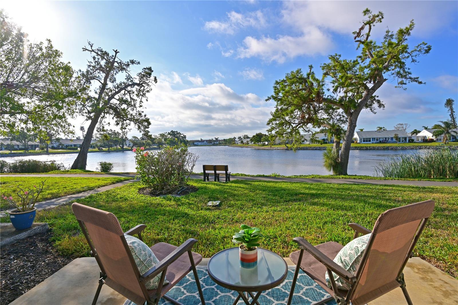 WELCOME TO YOUR NEW WATERFRONT OASIS! This lovely single-level villa offers a seamless blend of comfort, style, and an unbeatable location in a vibrant bay and canal front community spanning nearly 90 acres of paradise. It’s nestled on a quiet private street with no through traffic. BREATH-TAKING WATER VIEWS- From the moment you step through the door, you’ll be captivated by sparkling water views that invite the outdoors in. Evenings bring the magic of stunning sunset skies reflected on the water, providing the perfect backdrop for relaxation and enjoyment. PEACEFUL AND INVITING OUTDOOR SPACES- This villa is designed for tranquility and connection with nature. Enjoy a serene front porch setting or unwind on the back patio overlooking picturesque views. Enjoy grilling your favorites for family and friends in either space. For those who love community interaction, a leisurely walk along the meandering paths will lead you to the clubhouse and a host of amenities. MOVE-IN READY AND RECENTLY UPDATED- This home is move-in ready, updated, and partially furnished, including essential housewares (see inventory list). Meticulously maintained and squeaky clean, the villa boasts numerous updates. 2023: Roof, air conditioning system, refrigerator, toilets. 2022: Electrical panel, carpet, range, dishwasher, ceiling fans, lighting, blinds, smoke detectors, 3rd nail in roof-wall connectors. 2021: Patio. 2019: Dryer, microwave, backsplash, interior paint, vanity, faucets, washer/dryer hookups, fixtures, epoxy carport floor. 2018: Water heater. KITCHEN- Bright, airy, and full of cheerful charm. The all-white design creates a fresh, inviting atmosphere, while the convenient pass-through enhances the flow between spaces—perfect for casual conversations with guests. Plus, enjoy stunning water views as you cook or entertain. THOUGHTFUL DESIGN FEATURES- Split Bedroom Floor Plan and abundant storage ensures privacy for everyone and a place for everything. PRIMARY SUITE- Located at the quiet back of the villa with serene lake views, a spacious walk-in closet with attic access for additional storage, and an ensuite bathroom featuring a walk-in shower with safety bar. SECONDARY BEDROOM- Positioned at the front has a conveniently located adjacent bathroom with a tub/shower combo with safety bar. AIR-CONDITIONED LANAI- Sliding glass doors from both the living room and primary bedroom open onto the lanai, seamlessly expanding your entertaining space. These large windows allow you to enjoy serene views of the sparkling water. ATTACHED CARPORT- Features durable epoxy flooring and a 12’ x 5’ secure storage area, ideal for electric bikes, beach gear, and sports equipment. COMMUNITY FEATURES- Remodeled clubhouse, banquet room, game room, billiards, ping-pong, library/media center, exercise room, heated pool, tennis, pickleball, bocce ball, shuffleboard, spa, sauna, workshop, chipping/putting green, walking paths, butterfly garden, bayfront park, kayak launch/storage, bayside pavilion, lakeside gazebo, bird sanctuary, tidal pond, and more! DUES COVER- water, sewer, trash, recycling, pest control, cable with HD box, internet with router, exterior maintenance/repairs, landscape maintenance, and insurance. Mt Vernon on Sarasota Bay is amenity rich and maintenance free offering an unapparelled lifestyle and GREAT VALUE! This villa is your gateway to a life of comfort, peace, and natural beauty in sunny Florida. Schedule your visit today and discover your new home in paradise!