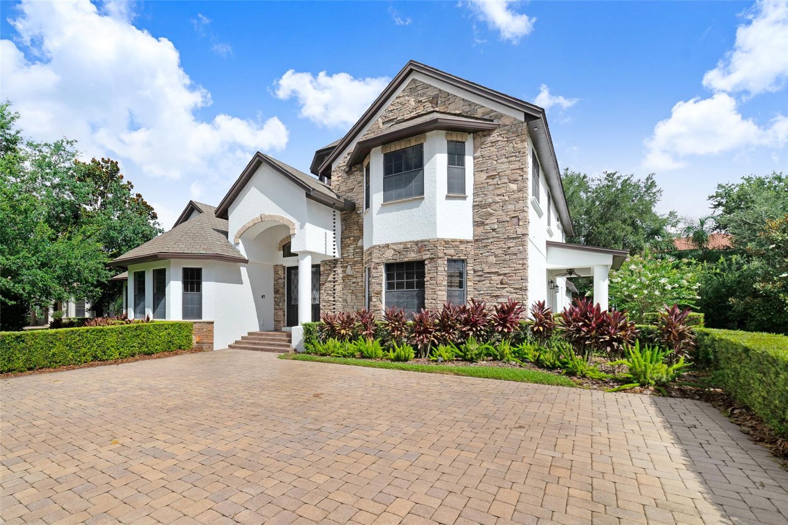 One or more photo(s) has been virtually staged. Located in the highly desirable guard gated, golf course community of Keene’s Pointe this incredible, custom home built by Sunscape Homes features many luxurious upgrades that are certainly sure to impress! This home exudes luxury and offers five bedrooms and four bathrooms to suit the entire family. Three bedrooms/bathrooms including the primary bedroom are conveniently located on the first floor. A spacious office/study along with a French theme inspired gourmet kitchen, living room, family room and dining space complete the spacious first floor layout. The chef’s dream kitchen features a large island for family dining and offers a new refrigerator and dishwasher. The travertine backsplash and custom accents highlight this one-of-a-kind kitchen. Wine lovers will enjoy the wine cellar for entertaining and showing off their most discerning selections. Upstairs features two additional bedrooms with a Jack and Jill bathroom as well as a vast loft/flex space for total family enjoyment. The balcony with fireplace has recently been screened in for complete comfort while enjoying gorgeous sunsets. The courtyard saltwater pool features a summer kitchen with gas grill and fireplace and the whole home audio system provides that resort style feel! Energy efficiencies include three tankless water heaters and an upgraded energy efficient Icynene insulated roof. The home has a large front driveway and the rear of the home with three car garage faces a quiet cul de sac for endless outdoor enjoyment! This home is conveniently located just minutes from Walt Disney World, Downtown Winter Garden and major thoroughfares with easy access to downtown Orlando and many local area attractions.
