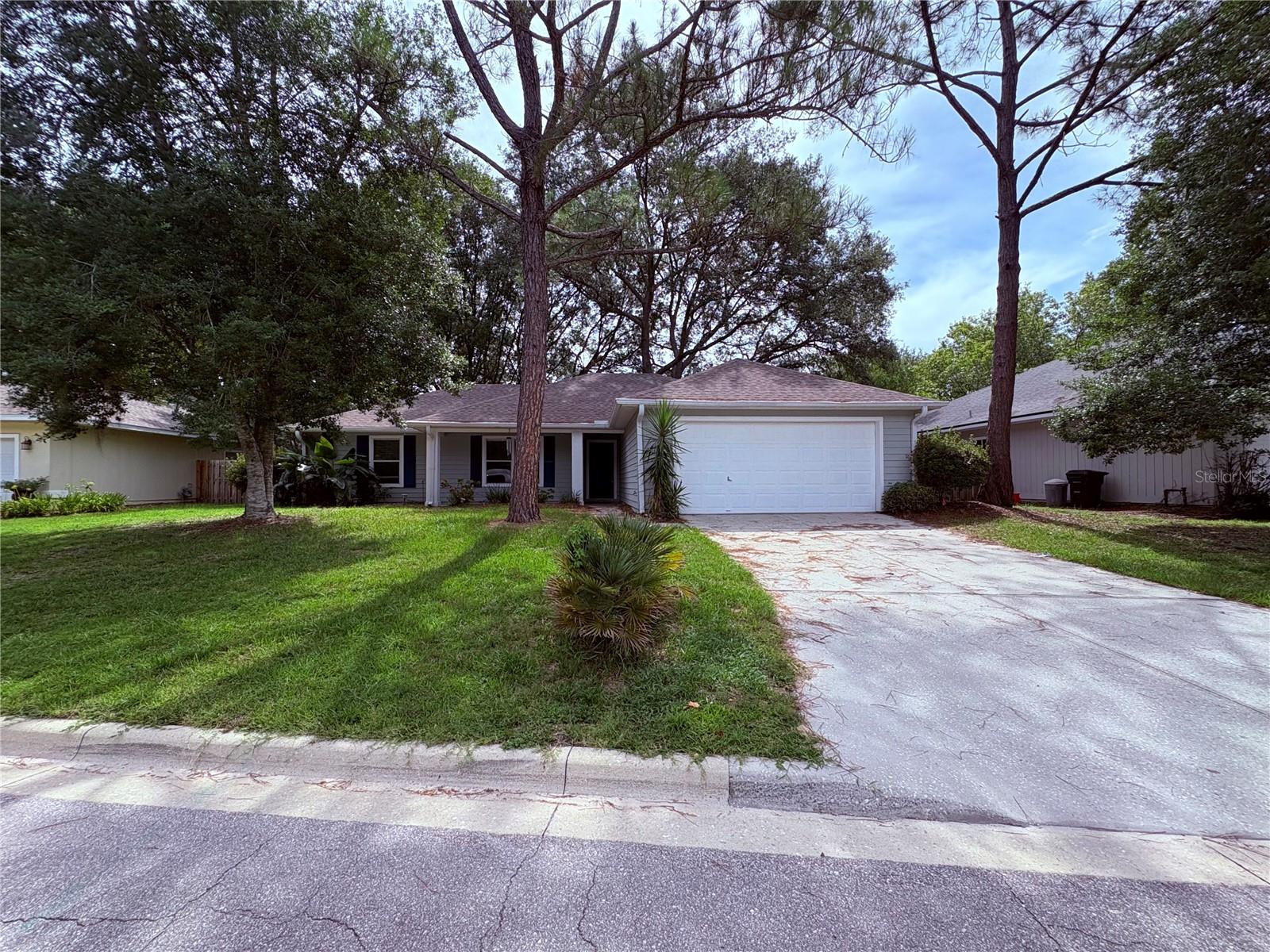 Come on and see me, located on a cul de sac. As you walk into the home, you are greeted with a large great room with patio doors leading out to a screen covered patio, over looking a large backyard. Inside the split floor plan ensures privacy, while the additional bedrooms offer flexibility for guests or a home office. You'll love the spacious primary suite featuring a walk-in closet, double vanity sinks, and separate shower area. There is a large eat in kitchen with a breakfast nook overlooking the backyard, brand new stove, microwave and fridge. Loys of cabinet space for storage. Living in Capri is a lifestyle. Enjoy access to a resort-style pool and hot tub, freshly refinished tennis and basketball courts, a gym, and a clubhouse available for private events. Wander the tree-lined walking trails or relax knowing the HOA takes care of neighborhood upkeep, including leaf and debris clearing from the roads. And all of this comes with a surprisingly low monthly fee of $94. Conveniently located just off NW 34th Street, roof is 2017, A/C is 2021 and water heater is brand new.