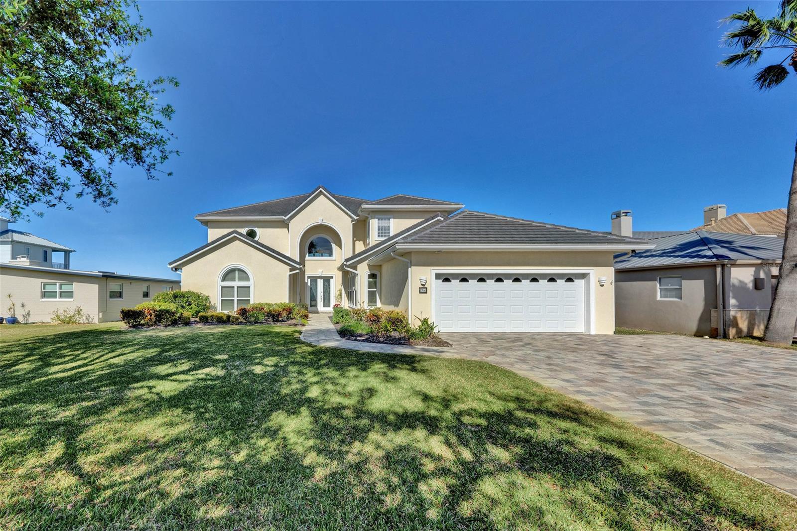 Welcome to A boater's Paradise! Experience the ultimate Florida lifestyle & your very own piece of waterfront sanctuary. When you arrive you'll be awestruck with 20ft-high ceiling & a panoramic view of intracoastal waterways & shorelines, just moments to Disappearing Island & to the Atlantic Ocean via Ponce Inlet. Watch the light house each evening from your own back yard. This exclusive Estate home offers an ELEVATOR with many safety features along with grand wooden stairways to the second floor. The unique floor plan of this fantastic home is designed with 4 separate wings, offering 3 master suites, and 4 large guest bedrooms with Jack and Jill Baths (total of 7 BD/6.5 BA). First floor offers 2 master suites with their own bathrooms , laundry closet & guest 1/2 bath in one wing . The other wing offers two secondary large bedrooms with Jack & Jill bath which would make a great in-law suite (total of 4 Bedroom down stairs ). The main owner suite with seating area, bay windows leads to balcony & spectacular water views is located on the second floor along with two large secondary bedrooms (one currently is being used as an office) & a Jack & Jill bath with a large laundry room all located on the other wing . Enjoy entertaining friends & family in the dinning area with bay windows & stunning water views, opening to large gourmet kitchen with an Island and two closet pantries leading to the a specious family room with a gas fire place . The outdoor entertainments offer a spectacular heated pool with salt system, a large spa, a full Pool bath, hurricane shutters & the boat house with a new lift . Other features include 3 A/C units w/ heat pumps & a separate heating furnace, new top of the line Rheem gas water heater & over sized 2 car garage. This Executive water front home & its location present the ultimate Florida beach lifestyle living, perfect for a large family within close approximately to shopping, dinning & US1 HWY. Be sure to see the Video of this home. ;Water: City