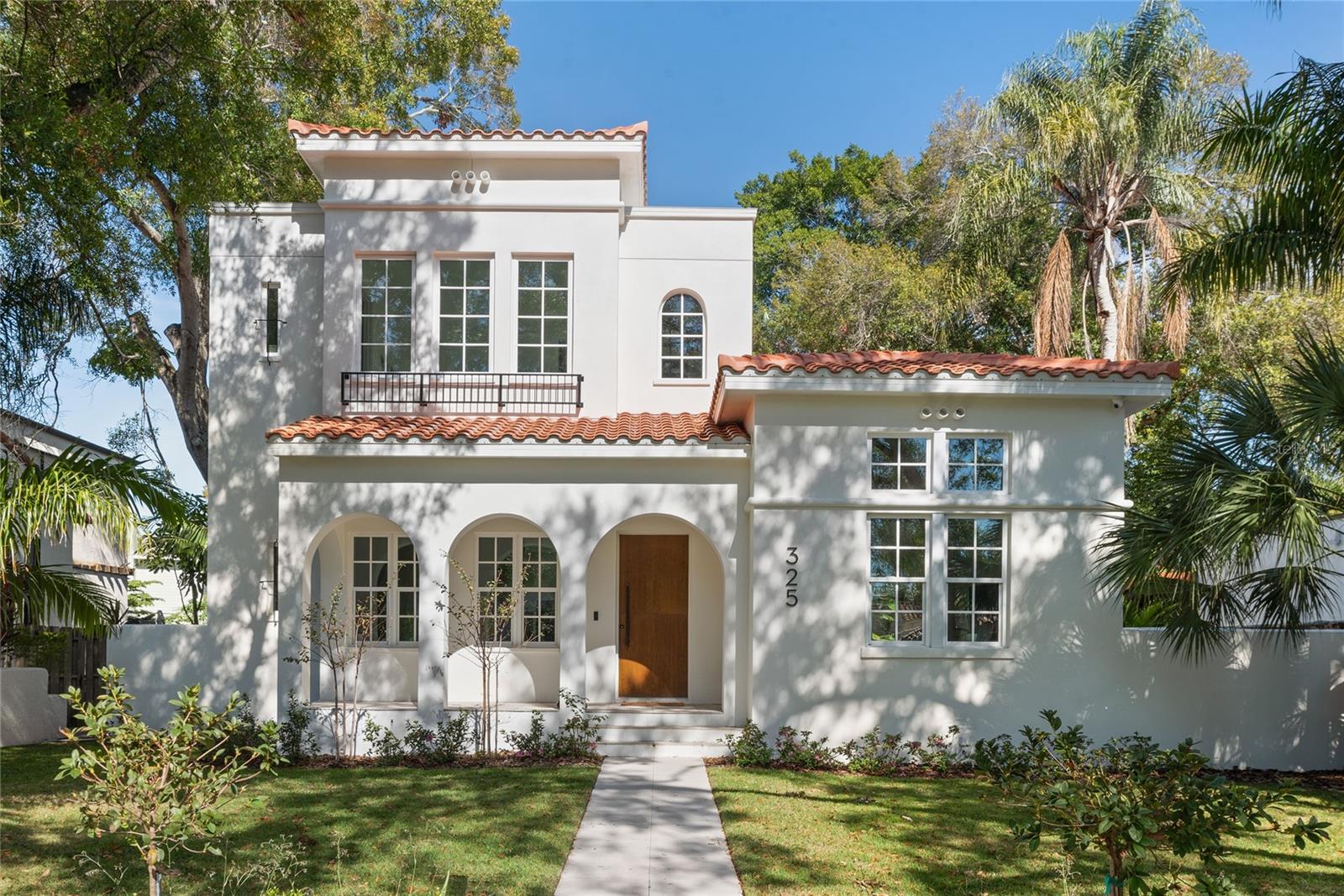 Nestled in the heart of one of St. Petersburg's most desirable neighborhoods, Historic Old Northeast, this exceptional 2022 custom-built residence by Modern Tampa Bay Homes – Tampa Bay's premier luxury home builder – presents an unparalleled opportunity for sophisticated living. Spanning 3,164 square feet of meticulously designed space, this property offers four generously proportioned bedrooms with high ceilings, and four and a half exquisitely appointed bathrooms, creating an ideal balance of comfort and elegance.
Upon entering, one is immediately struck by the home's thoughtful design, where wide-plank European white oak hardwood floors flow seamlessly beneath soaring ceilings. The southern exposure bathes the interior in natural light, enhancing the carefully curated designer lighting that includes statement chandeliers and recessed accents. The open-concept layout effortlessly connects living spaces, creating an environment equally suited for intimate family gatherings and grand-scale entertaining.
The chef's kitchen stands as a testament to both form and function, featuring professional-grade Dacor appliances including an induction range and double oven. A substantial center island provides ample workspace and casual seating, while the adjacent eat-in area offers a relaxed dining space with easy access to the outdoor living areas through expansive 10-foot glass sliding doors that slide into the wall creating a seamless indoor outdoor entertaining space to the pool deck.
Outdoor living reaches new heights with a resort-style heated saltwater pool surrounded by generous patio and terrace spaces. The professionally designed outdoor kitchen, complete with built-in barbecue transforms al fresco dining into a daily luxury. The private walled yard, thoughtfully landscaped for both beauty and privacy, creates a serene retreat just steps from home.
Modern conveniences abound throughout the residence, including a comprehensive smart home system with integrated security and video surveillance. Kasa light switches and nest thermostats can be controlled from your smartphone. Practical luxuries include a dedicated laundry room, locked glass wine storage room , and a 2 car garage with plenty of storage. The property's prime location places residents within easy walking distance of Vinoy Park's waterfront splendor and downtown St. Petersburg's vibrant cultural scene, with its acclaimed restaurants, boutique shopping, and world-class art galleries including the Dali Museum and Chihuly Collection. The Vinoy Golf Club lies just a short golf cart ride away, while boating enthusiasts will appreciate the proximity to St. Petersburg Municipal Marina and St Pete yacht Club.
This Modern Tampa Bay Homes creation represents the pinnacle of contemporary luxury living, where every detail has been carefully considered and expertly executed. It stands as a rare offering in St. Petersburg's most sought-after neighborhood – a residence that perfectly balances architectural significance with everyday livability, all within reach of the city's finest amenities.
An exclusive viewing of this remarkable property can be arranged by appointment, offering discerning buyers the opportunity to experience firsthand this exceptional example of modern luxury living at its finest.