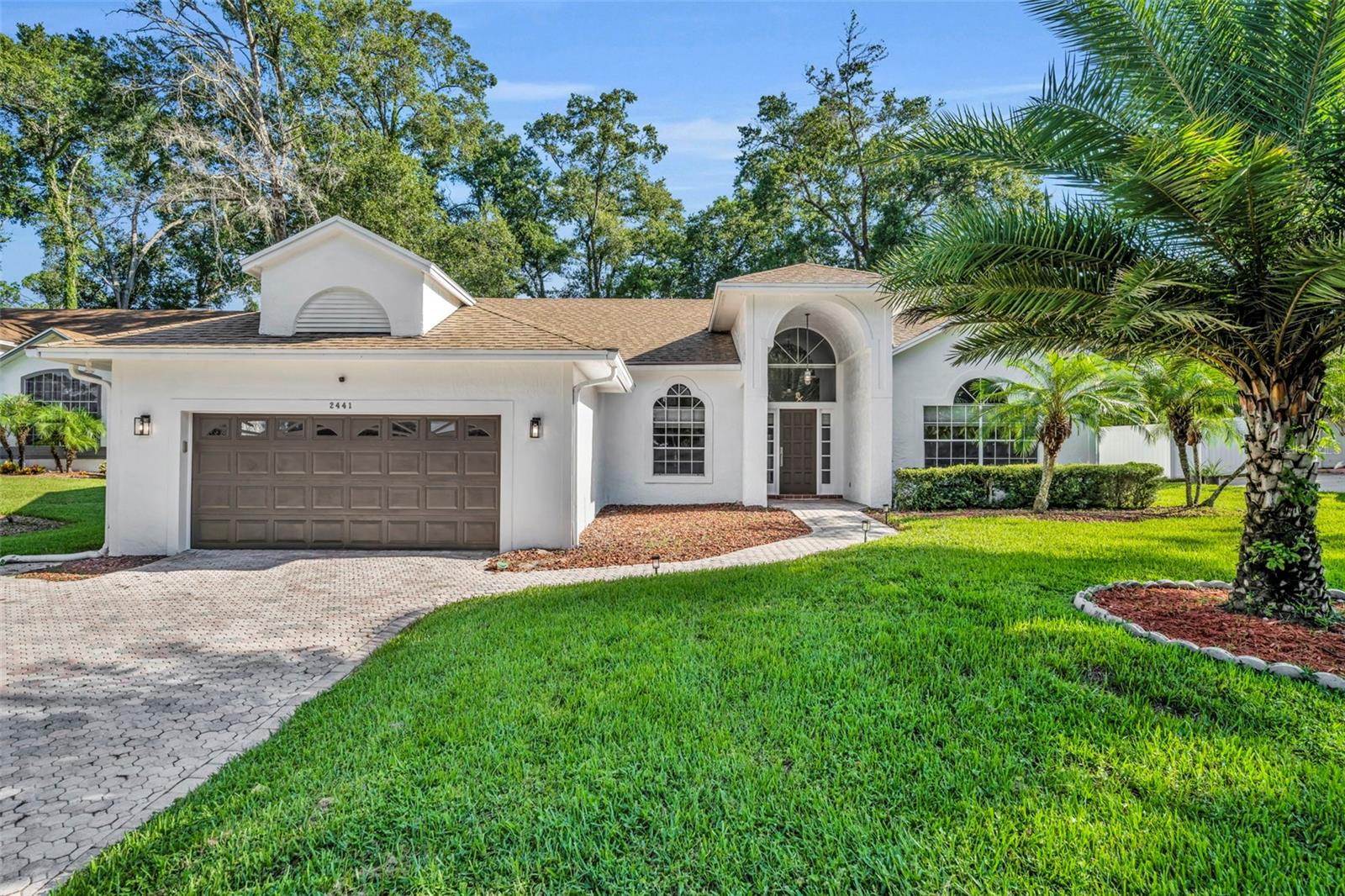 Welcome to your private retreat in the heart of one of Central Florida’s most desirable golf & lake access communities! This beautifully updated 4-bedroom, 3-bath pool home offers 2,434 square feet of modern living with a thoughtful 3-way split bedroom plan. Step inside to a light and fresh interior with contemporary gray tones, striking dark moldings, and an inviting electric fireplace. The open kitchen is a chef’s dream, featuring stainless steel Jenn-Air appliances, quartz countertops, a closet pantry, built-in desk, and even a beverage fridge and deep freezer in the garage for added convenience. Designed for entertaining, the home boasts a spacious screened lanai with a sparkling pool and heated spa—both with newer equipment—plus an additional outdoor patio perfect for gatherings. The oversized, fully fenced yard offers privacy and space to play, relax, or garden. The large primary suite is a true retreat with dual custom closets and a luxurious spa-style bath showcasing three shower heads and a jetted soaking tub. Bedrooms 3 and 4 share a Jack-and-Jill bathroom, while Bedroom 2 has its own access to the pool bath—ideal for guests or multi-generational living. Located in a highly amenitized community with deeded access to spring-fed Lake Brantley (including private boat ramp), kayak launch to the Wekiva River, and an array of recreational options: tennis, pickleball, volleyball, baseball, golf, two clubhouses, and an on-site restaurant. This home is the complete package—modern, move-in ready, and perfectly placed for the Florida lifestyle.