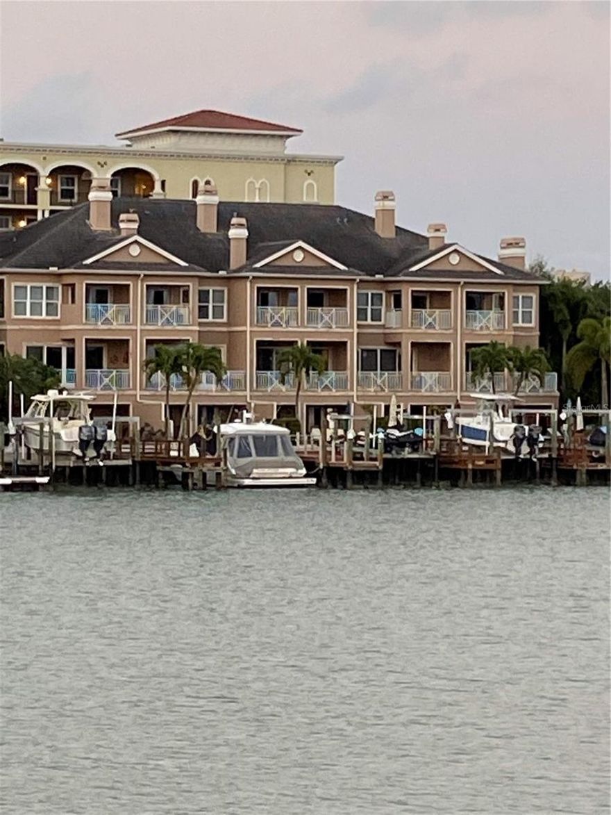 SELLER FINANCING AVAILABLE!  BREATHTAKING VIEWS FROM THIS RARELY AVAILABLE END UNIT TOWNHOME IN THE MOST DESIRED AND SOUGHT AFTER BUILDING ON ISLAND ESTATES!   IMMERSE YOURSELF IN THE ULTIMATE COASTAL LIFESTYLE IN THIS THREE-STORY HOME WITH  APPROXIMATELY 5,500 SQ. FT OF LIVING SPACE, IF YOU COUNT THE EXTRA BONUS ROOM DOWNSTAIRS.   STEP OUT BACK ONTO YOUR BRICK PAVER PATIO AND TAKE A DIP INTO YOUR PRIVATE OASIS HEATED SWIMMING POOL WITH WATERFALL  AND WATCH DOLPHINS SWIM BY OR ENJOY BOATING AND FISHING ON YOUR   54’ X 20’  DEEP WATER DOCK.  EVERYTHING YOU COULD WISH FOR AND MORE!   WATCH THE  SUNRISE AND SUNSETS DAILY  WITH  PANORAMIC WATER VIEWS OF THE GULF OF MEXICO AND THE INTER-COASTAL FROM YOUR BALCONY.      HUGE LIVING ROOM OFFERS A TRAVERTINE NATURAL GAS FIREPLACE, WET BAR, WINE COOLER AND WALL TO WALL OF GLASS WINDOWS AND SLIDING GLASS DOORS LEADING TO A BALCONY OVERLOOKING YOUR SPECTACULAR VIEWS AND .   YOUR BEAUTIFUL KITCHEN INCLUDES CUSTOM WOOD CABINETS, GRANITE COUNTERS, BACKSPASH, BREAKFAST BAR, NEW THERMADOR GAS RANGE WITH ELECTRIC OVEN, AND YOUR BUILT-IN THERMADOR REFIDGERATOR WITH OVERSIZED STAINLESS STEEL FARMERS SINK AND WINDOW SEAT.   EVERY BEDROOM HAS IT’S OWN PRIVATE BATH.    YOUR SPACIOUS LUXURIOUS PRIMARY EN-SUITE OFFERS INCREDIBLE VIEWS,  PRIVATE BALCONY, SITTING AREA, GAS BURNING FIREPLACE, WALK-IN CLOSET, AND IMPRESSIVE BATHROOM WITH SOAKING TUB AND SEPARATE WALK-IN SHOWER, AND DUAL SINKS.  SOME ADDITIONAL FEATURES THIS HOME OFFERS ARE ELECTRIC BLINDS, HURRICANE IMPACT SLIDING GLASS DOORS AND WINDOWS,  10’ CEILINGS THROUGHOUT, CROWN MOLDING, BEAUTIFUL WOOD LAMINATE FLOORING, LOTS OF NATURAL LIGHT, RECESSED LIGHTING, AND MUCH MORE!  JUST A SHORT DISTANCE TO THE WORLD RENOWNED CLEARWATER BEACH, PUBLIX GROCERY STORE, PHARMACY, BANKS, RESTAURANTS, DRY CLEANERS, NAIL SALONS, CHURCHES & JOLLY TROLLEY.   VERY LOW MAINTENANCE FEES OF ONLY $4,000/YEAR AND INCLUDES ROOF, PAINTING, AND OUTSIDE LAWN CARE. VERY LOW FLOOD INSURANCE.