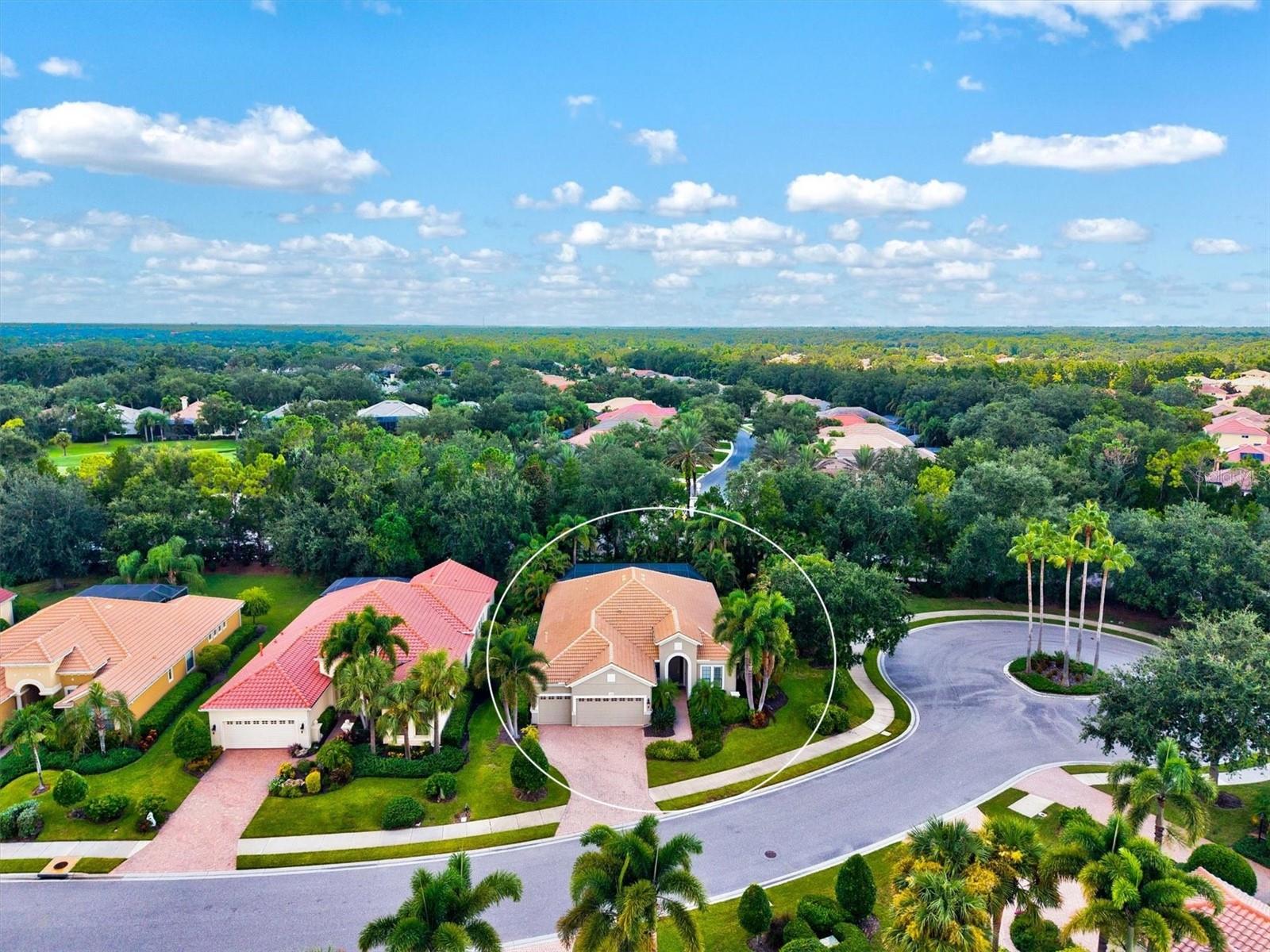 Immaculate Maintenance-Free Home in Stone Ridge at Lakewood Ranch Country Club. Located within the gates of Lakewood Ranch Country Club, this meticulously maintained Savona model by Neal Communities sits on a private oversized cul-de-sac lot. Offering nearly 2,500 sq. ft. of living space, the home features 3 bedrooms, a den, and a 3-car garage. Step inside to soaring 10-foot ceilings with coffered details, crown molding in every room, plantation shutters, and custom window treatments. Tile floors flow throughout, with wood-look plank tile in the owner’s suite, den, and bedrooms. All lighting and ceiling fans have been thoughtfully updated. The den, accented with glass-pane French doors, provides the perfect home office or quiet retreat. The formal living and dining areas set the tone, while the open-concept family room with custom built-ins and disappearing sliders expands seamlessly to the lanai. The adjoining kitchen showcases upgraded cabinetry with glass-front uppers, granite countertops, stainless-steel appliances, a built-in desk, breakfast bar, and casual dining nook.
The spacious owner’s suite offers lanai access, a sitting area, and an en suite bath with soaking tub, dual vanities, walk-in shower, private water closet, and a custom-fitted walk-in closet. Outdoor living is unmatched here. This home boasts the largest lanai in the neighborhood, highlighted by a sparkling pool and spa, custom gas fireplace, lush landscaping, and complete privacy. The outdoor kitchen features granite counters, a gas grill, side burner, refrigerator, and sink. A covered dining space, cabana bath, and outdoor shower make this a true retreat for relaxing or entertaining. Membership at Lakewood Ranch Country Club is optional, but available, with access to golf, tennis, fitness, dining, and resort-style pools. All this, just minutes from award-winning beaches, fine dining, and world-class shopping.