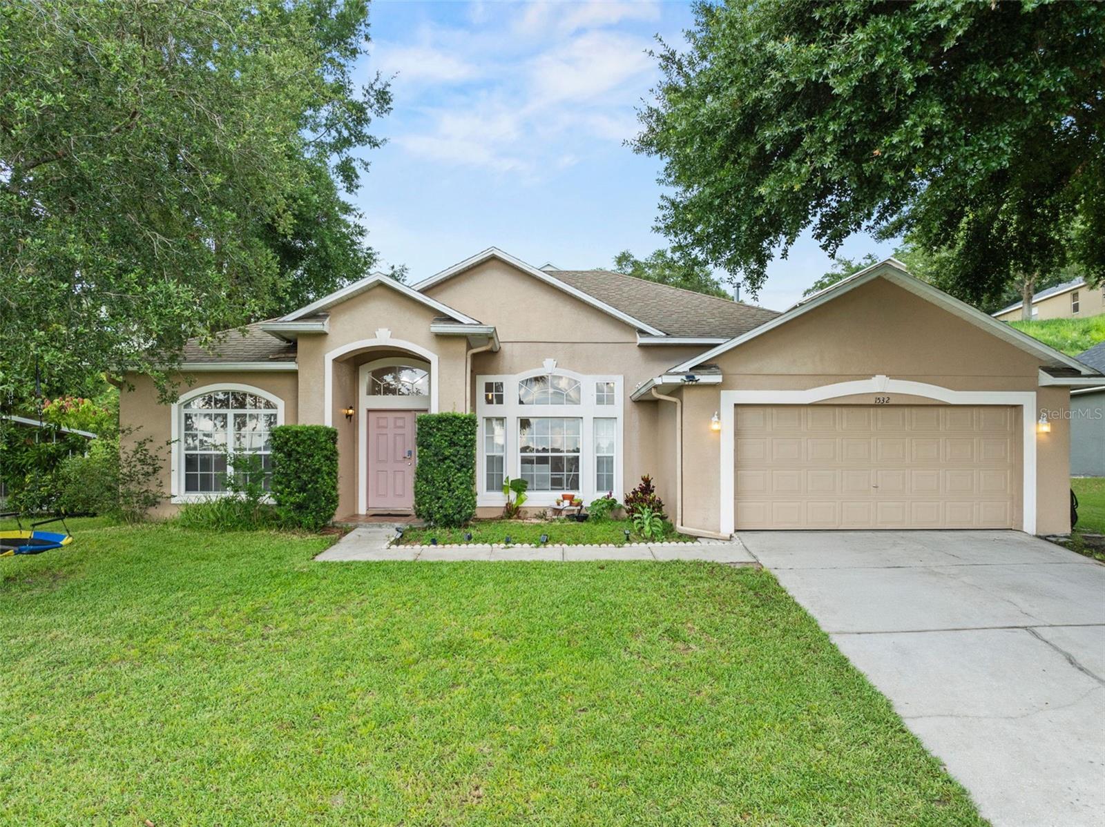 Welcome to this bright and beautiful 4-bedroom, 2-bath home nestled in the heart of Clermont. Designed with comfort and style in mind, this spacious residence features an open floor plan with sleek ceramic tile flooring throughout. The kitchen is boasting stainless steel appliances, granite countertops, and spacious cabinets. Three sliding glass doors flood the home with natural light and allow fresh spring breezes to flow through. The primary suite includes soaker tub, walk-in shower and walk-in closet. Every room feels airy and inviting thanks to the home’s generous natural light. Step outside to the large screened-in lanai, perfect for relaxing or entertaining with privacy. Complete with a two-car garage and a layout ideal for everyday living or hosting guests, this home truly has it all. Don’t miss your chance to make it yours!