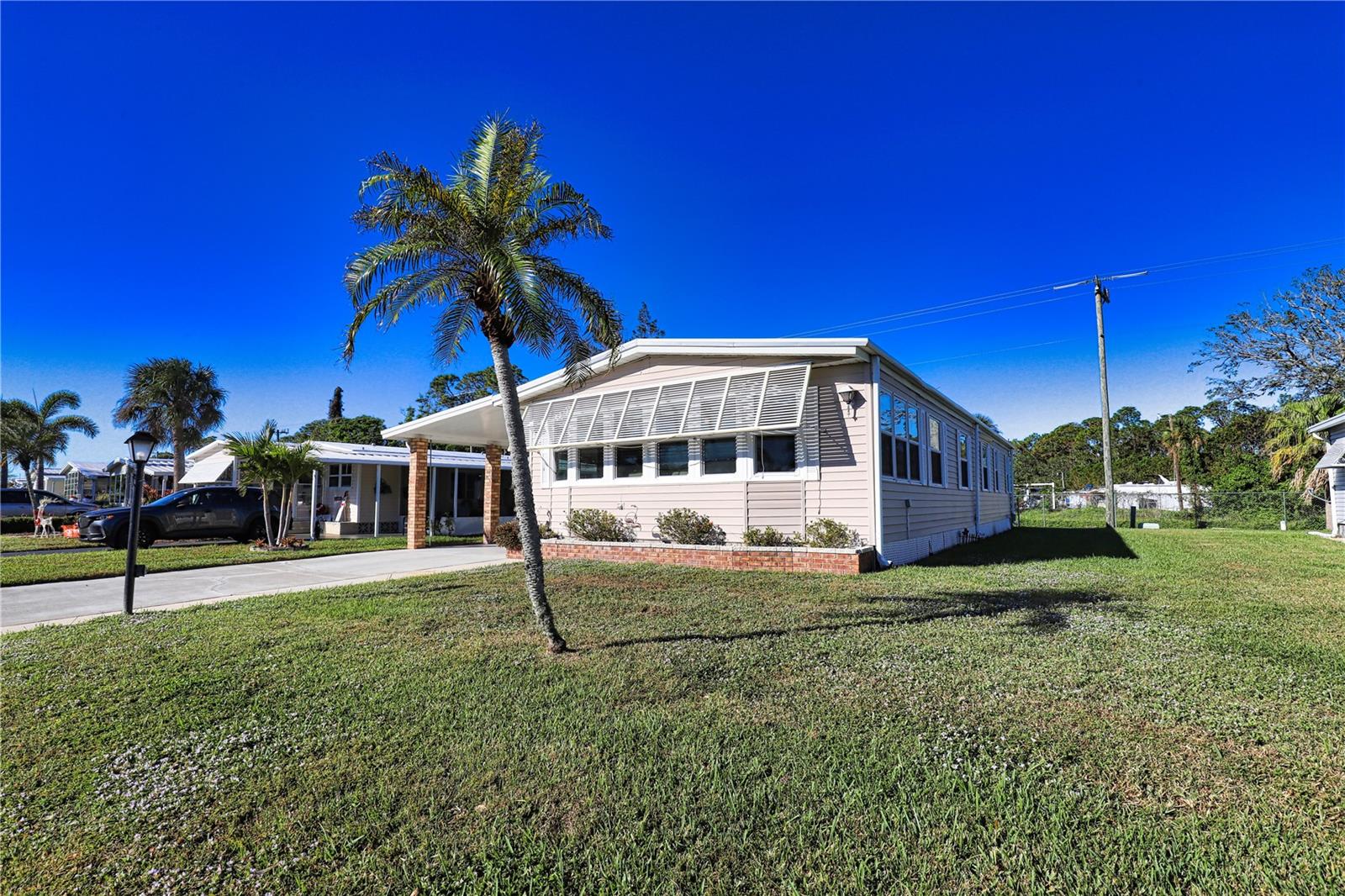Don’t miss this unique must-see home in the pet area of our vibrant 55+ community. You’ll see lots of updates and upgrades throughout. As you enter the Florida Room, you’ll notice it’s generous size and that it’s under-air for added comfort. It also includes an over-sized storage shed with laundry room. Upon entering the home you’ll see that the open concept kitchen, dining room, and extended living room all flow in a way that makes it perfect for entertaining friends and family. The extension of the living room will also be the perfect spot for cozy nights in front of the tv or reading a book. The primary bedroom and ensuite bathroom are extremely spacious with an updated marble shower and sizable walk-in closet. The guest bedroom is also quite comfortable with the bath right across the hall. New subflooring and home is being offered turn key.
La Casa boasts 974 homes nestled among a variety of native trees with spacious common grounds surrounding our eight lakes. Our lots average a generous 60' by 80'. The ultimate lifestyle on Florida’s Gulf Coast is located between Sarasota and Fort Myers and is a boater's dream with access to the Gulf of Mexico. It is convenient for shopping, sightseeing, golfing, fishing, and boating, as well as all the culture and elegance the Southwest Florida area is noted for. Residents and visitors enjoy the warmth of Southwest Florida winters in a relaxed and unhurried environment far removed from the hustle of Florida’s east coast. You’ll be surrounded by mature lush landscaping which demonstrates the utmost level of care our property receives from residents and management. La Casa may have the best pools in the area. Our crown jewel is an extremely large, 40 X 60-foot swimming pool that is kept at a perfect 87 degrees. Our smaller 20 x 40 pool is quietly nestled between the clubhouse and the Activity Building. Both pools have adjacent hot tubs which are ideal for soaking muscles that are tired from golfing or tennis. Wireless Internet (Wi-Fi) is available at the Clubhouse, Activity Building, and Recreation Hall area where these pools & spas are located, so you can catch some rays while you catch up on your email! Sound enticing? La Casa is a friendly, family community. You will be away from the hustle and bustle except when you want to be part of it. Come for a visit to this self-contained oasis and see for yourself why La Casa is the ultimate destination for both snowbirds and year-round residents!