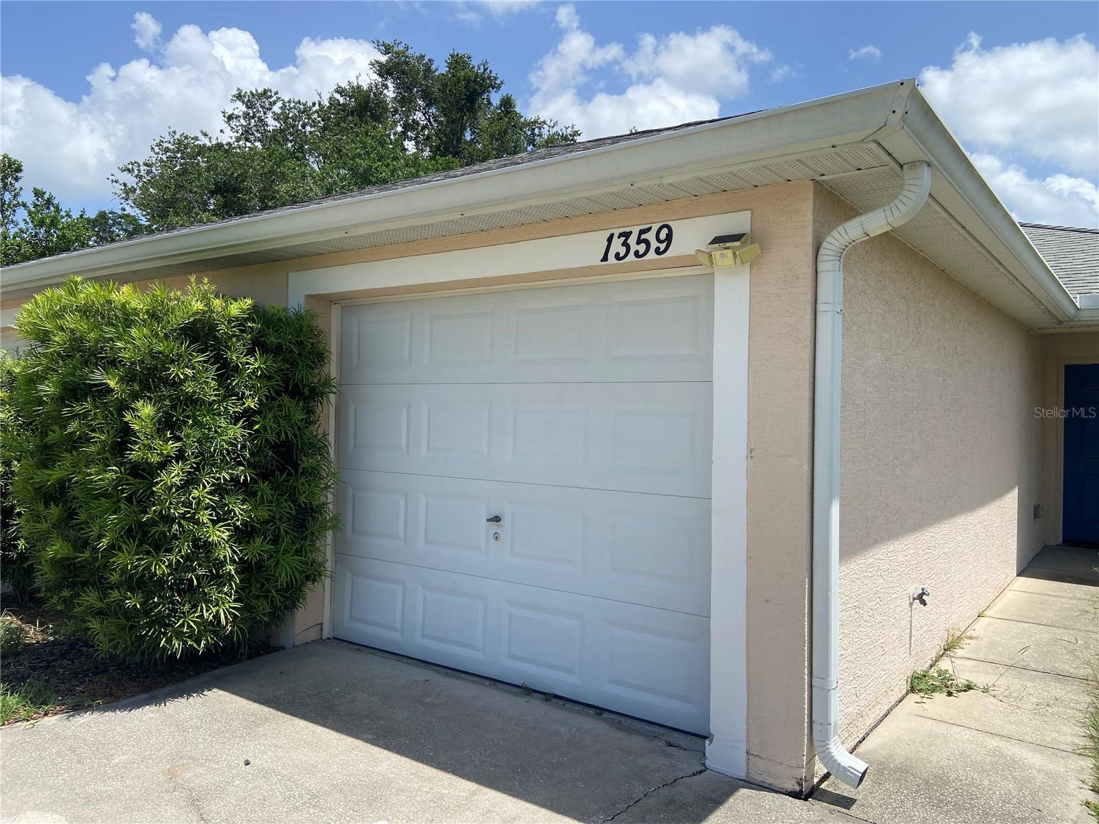 1359 E. Evans Cir, Unit B is a 2 bedroom, 2 bath, 1,118 sq ft duplex with a one car garage in Deltona. The home welcomes you into the spacious living room and dining room area featuring high ceilings. The kitchen hosts a suite of appliances including the refrigerator, range and dishwasher. The dual kitchen sink overlooks the open living area. This home has tile floor throughout the main living areas. Continuing through to the master bedroom, it features sliding glass doors leading to the patio and backyard area. The master bedroom features private access to the master bath, with a walk in shower. The entrance through the one car garage leads you to the laundry room with washer and dryer hookups. The garage features additional storage space.