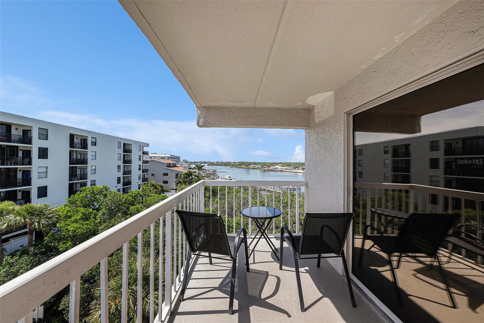 Here is a great opportunity to own a beach getaway while producing income or to live the beach life.
Water View, a quiet beachfront condominium complex of 35 units, has the highly sought-after weekly zoning designation, making this a superb investment or 1031 tax exchange. Walking distance to many restaurants, and a quick drive to grocery stores and other amenities makes this a fabulous location. With elevator access, this 4th-floor condo is unique as only five units in the complex have this spacious open floor plan and no shared walls. The unit itself is a true split plan with two separate master ensuites each having its own bathroom and private balcony. The bedrooms are separated by the Great Room, which overlooks the pool and also has access to each balcony and kitchen, making this 1,125 sq. ft. of living space feel open, airy, bright, and spacious. The nicely updated kitchen area features a granite breakfast bar, dining area, and laundry room. The main ensuite offers a king-size bed, TV, and convenient closet organizers for long and short-term stays. The secondary ensuite sleeps 4 offering a queen bed along with bunk beds, TV, and also convenient closet organizers. Enjoy the intracoastal water views from your private balcony or spend time on the Gulf beach which is just steps away via the private deeded beach access.
Enjoy the heated pool and hot tub. Catch some fish from the private Intracoastal pier and cook them up on the poolside grill. Bathrooms are convenient at the atrium on the ground level, 1 assigned parking space with available guest parking. With this smaller complex no need to worry about an overcrowded pool.
The building will be undergoing spectacular renovation, and its outcome will be beautiful epoxy-coated hallways and balconies, and new stairs leading to all floors amongst other upgrades immensely increasing the value of your purchase. Whether you live here full-time, use it as a seasonal getaway, or as an income property, you’ll enjoy this location.