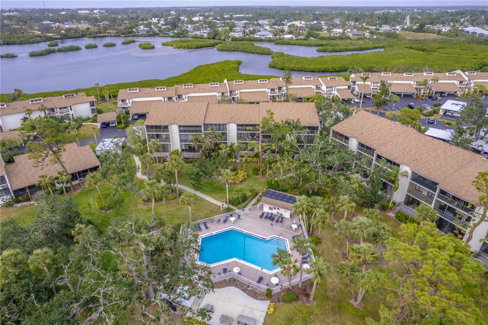 Welcome to Paradise at 832 Bird Bay Way and discover maintenance-free living in this updated **GROUND FLOOR CONDO** nestled in Bird Bay Village! This 2 bedroom 2 bath unit comes turnkey furnished and features luxury vinyl flooring throughout in an open-concept living space. The living room flows effortlessly to the serene views from your titled enclosed lanai, which opens up to a charming deck just steps away from Phase II pool, making it ideal for both everyday living and entertaining. The kitchen boasts granite countertops with stainless steel appliances and wood cabinetry. Both bathrooms have been updated with granite countertops, the guest bath features a tub with shower and primary bedroom with an en-suite bathroom has a updated tiled shower. This home's unbeatable location pairs perfectly with the amenity-rich community offering multiple pools, tennis and pickleball courts, a fitness center, library and clubhouse. Engage in a vibrant social activities, and events year round. Bird Bay is adjacent to the Legacy Trail for biking and walking, just minutes from Historic Downtown Venice. Whether you're seeking a seasonal retreat, forever home, or income-generating rental, this property delivers it all! Schedule your showing today and experience Venice coastal living at its finest!