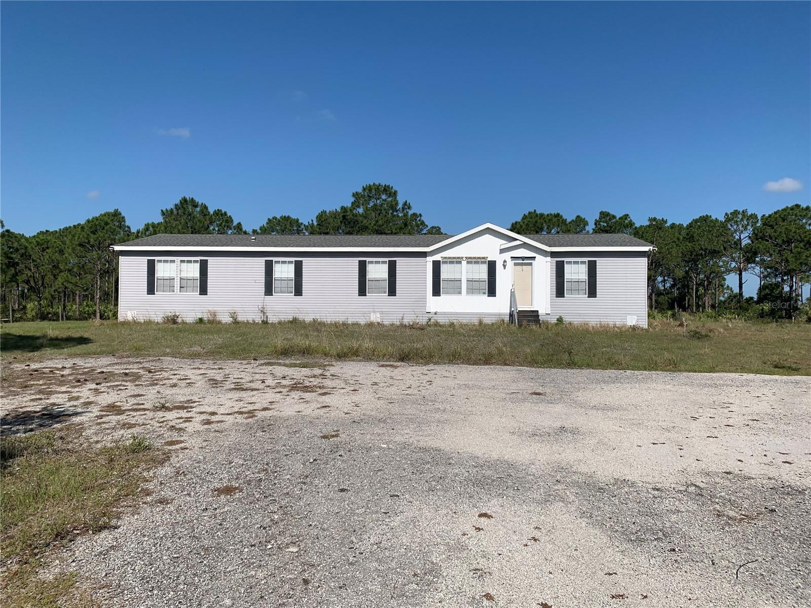 FAMILY HOMESTEAD -- 38.85 Acres of pasture, prime for livestock. 4 Bed 2 Bath mobile home with elegant details, perfect for family living. Wood-burning fireplace, open kitchen, 2 family rooms, and large laundry room.