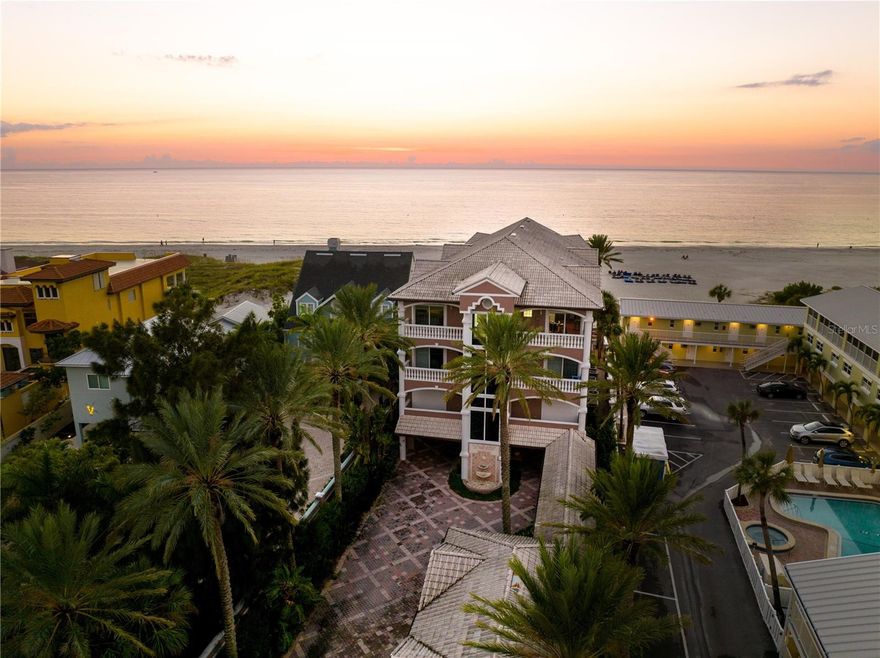 Welcome to the Penthouse at Casablanca on the Beach — A Rare Gulf-Front Retreat with Unmatched Panoramic Views. Perched on the third floor of an exclusive, gated enclave of just three residences, this impeccably maintained penthouse offers sweeping, unobstructed views of the Gulf of Mexico. As you arrive through the private gates of Casa Blanca, you're welcomed by your expansive five-car garage—a rare find in beachfront living. Your private glass-front elevator delivers you directly to a grand foyer adorned with custom wood entry doors, setting the tone for the refined luxury within. Inside, you're greeted by gorgeous marble flooring, dramatic arched openings, and architectural details that exude elegance and timeless design. With over 3,500 square feet of thoughtfully designed living space, this home is ideal for both everyday comfort and lavish entertaining. The 10-foot coffered ceilings, 8-foot arched entryways, and designer finishes throughout create a residence of elevated distinction. The chef’s kitchen features cherry-finished cabinetry with pull-outs, an oversized breakfast bar with seating for five, high-end appliances including a Sub-Zero refrigerator, and ample storage. A custom bar area with a wet bar, dishwasher, and extensive cabinetry enhances your ability to entertain in style. The floor plan includes a formal living room, dining room, and a family room, all thoughtfully arranged for flow and function. French doors from the formal living room open to an expansive covered balcony, offering front-row views of the sugar-white sands and turquoise waters of the Gulf. The primary suite is a sanctuary, offering breathtaking Gulf views from a private balcony, and a spa-like en-suite bath featuring dual vanities, a soaking tub, walk-in shower, water closet, and bidet. A second primary suite, an additional guest bedroom, and two more full bathrooms complete the sleeping quarters. Ascend the polished wood spiral staircase to a coastal-inspired upper-level retreat with access to another stunning balcony and additional panoramic views. The home also features a dedicated office/den with floor-to-ceiling built-ins, French doors, and its own private balcony — perfect for working from paradise. Additional highlights include a laundry room, ample storage, and thoughtful design throughout. Ideally located just moments from fine dining, coastal recreation, and boutique shopping, Casablanca on the Beach offers a rare blend of privacy, prestige, and proximity. Just a short drive to Tampa International Airport and St. Pete–Clearwater Airport, this penthouse is truly a once-in-a-lifetime opportunity to own a piece of Florida's most coveted coastline.