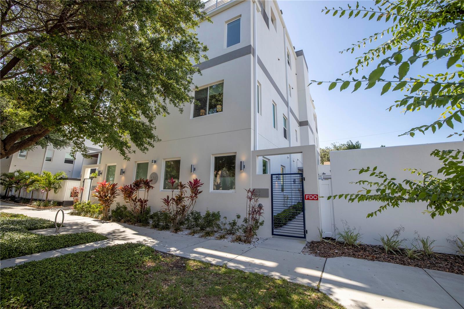 Incredible newer construction townhome for rent in downtown St. Petersburg. Three bedrooms, two full baths, two half baths, as well as an amazing rooftop terrace. First floor features open floor plan with modern kitchen featuring quartz countertops, soft-close cabinets and top of the line appliances. First floor living space also includes dining area that opens to living room, half bath and elevator access. Second floor features two guest bedrooms and one full bath, as well as laundry facilities with included washer and dryer. Third floor is devoted to the large master bedroom and bath. Bathroom has double vanities with quartz countertops and large walk-in shower with glass enclosure. Also features large walk-in master closet. Fourth floor includes large flex space for an office or den with half bath and large impact sliders going out to the rooftop deck. Also, elevator goes all the way to the top floor! Roof deck features outdoor kitchen with marble countertops, large stainless grill and fridge, as well as mounted outdoor television. This home also includes loads of smart features including Guardian security system, smart switches, iPad control panel, and surround sound. Separate one car garage is attached and has alley access. Unit includes two more parking spaces in front of the building. Property is located in a vibrant neighborhood with close access to downtown, Central Avenue and nearby hospitals, and the new St. Pete Pier!