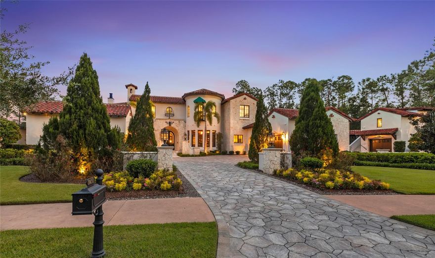 Nestled deep inside the coveted Carolwood neighborhood of Golden Oak at Walt Disney World® Resort, this nearly 11,000 sqft Mediterranean estate offers a rare combination of scale and one-of-a-kind details. Situated on a .79-acre lot, siding and backing to conservation, the home also enjoys serene pond views and ultimate privacy. Inside, soaring ceilings and a sweeping staircase set the tone, anchored by a custom crystal chandelier. A row of Disney-themed stained-glass windows adds a whimsical touch, overlooking the courtyard and sparkling resort-style pool. The chef’s kitchen overlooks a two-story great room and is designed for both function and beauty, featuring top-of-the-line appliances and extensive storage inside custom cabinetry. With 7 bedrooms and 7.2 baths, including a fully detached apartment over the garage, the layout is ideal for family or guests alike. The first-floor master suite is a private retreat, complete with two gas fireplaces, a sitting area overlooking the pool, and a spa bath with soaking tub and walk-in shower. Additional highlights include a Millennium Falcon–inspired theater, temperature-controlled wine room, Toothless pizza oven, an exact replica of the marble fireplace from Cinderella’s Castle apartment, and a massive game room perfect for entertaining, gaming, and/or homeschooling. Outside, the true resort-style setting is unmatched. A pool with grotto, spa, slide, and rock waterfall is complemented by multiple fire pits, expansive covered courtyards, and a summer kitchen for indoor/outdoor living. Car enthusiasts will appreciate the four separate garages, three outfitted with lifts to accommodate up to seven cars. Located just a short drive from Summerhouse and the Four Seasons Resort, this estate offers a rare opportunity to own one of Golden Oak’s most remarkable residences.