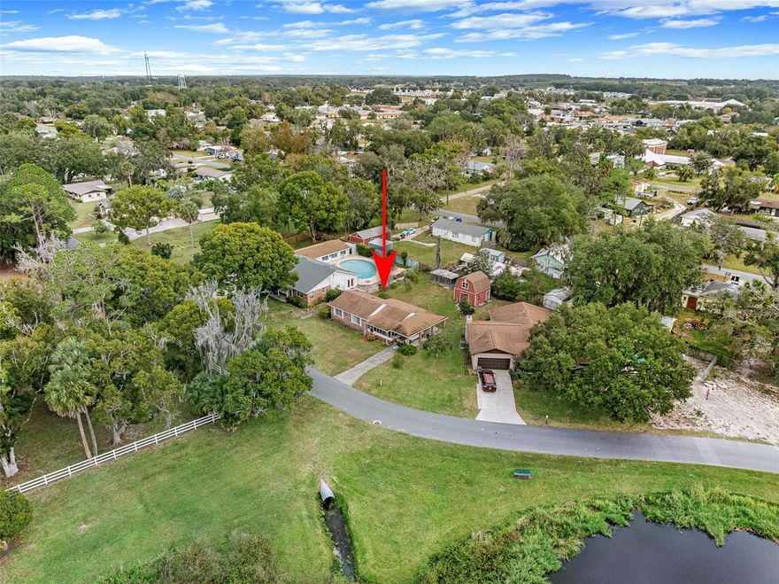 Located on a peaceful, quiet road, this solid home offers a great opportunity for a buyer ready to add their own updates and bring it back to life. Major improvements are already done, including a 2018 roof, 2020 A/C, and a new electrical panel.

Enjoy relaxing on the screened-in front porch with a direct view of the large pond across the street, where locals love to fish. The home also features a carport for covered parking and a large Florida room that could potentially be converted into a third bedroom or even an additional bathroom with the right vision, permitting, and upgrades.

Out back you’ll find a massive barn-style shed plus hunting dog kennels, offering tons of storage and flexibility (keep them, repurpose them, or remove them for more yard space). Public water and the “bones” of this home are strong, making it a smart option for someone wanting to build equity in a great area.

Conveniently located minutes to Save A Lot, about 15–20 minutes to Publix, 20–25 minutes to downtown Mount Dora, and around an hour to Orlando. This could be an excellent starter home or investment in the growing Umatilla area.