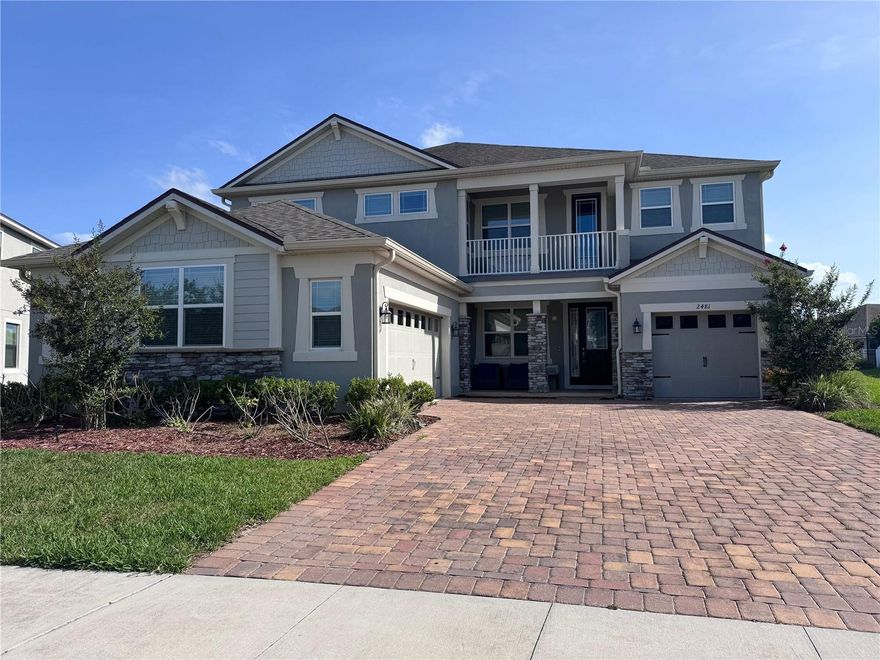 Welcome to luxury living in Kissimmee! With a guard-gated community, this exceptional home is situated on an oversized premium lot with breathtaking lake views, offering the perfect blend of comfort, elegance, and functionality. Designed to accommodate a variety of lifestyles, this spacious residence features a first-floor bedroom with a private bathroom and separate exterior entrance, currently customized as a media/theater room. This versatile extra room can easily serve as a guest suite, home office, multi-generational living area, or an in-law suite to suit your needs. The main living areas has 4 generously sized bedrooms and 4.5 bathrooms upstairs, providing ample space for family and guests. The heart of the home showcases a beautifully appointed kitchen featuring quartz countertops, wood cabinetry with crown molding, a large center island, and abundant storage, thoughtfully designed for both everyday living and entertaining. Premium upgrades can be found throughout the home, complementing the expansive living spaces and well-designed floor plan. Additional highlights include a 3-car garage, elegant finishes, and an abundance of natural light throughout. The oversized homesite provides endless possibilities for outdoor living, future enhancements, or creating your own private backyard oasis. Residents enjoy access to outstanding community amenities, including a clubhouse, resort-style swimming pool, fitness center, and recreational areas. Conveniently located near major highways, this home offers easy access to Walt Disney World, Universal Orlando Resort, shopping, dining, entertainment, and great schools. Don't miss this incredible opportunity to own a luxury lake-view home in one of Kissimmee's most desirable gated communities. Schedule your private showing today!