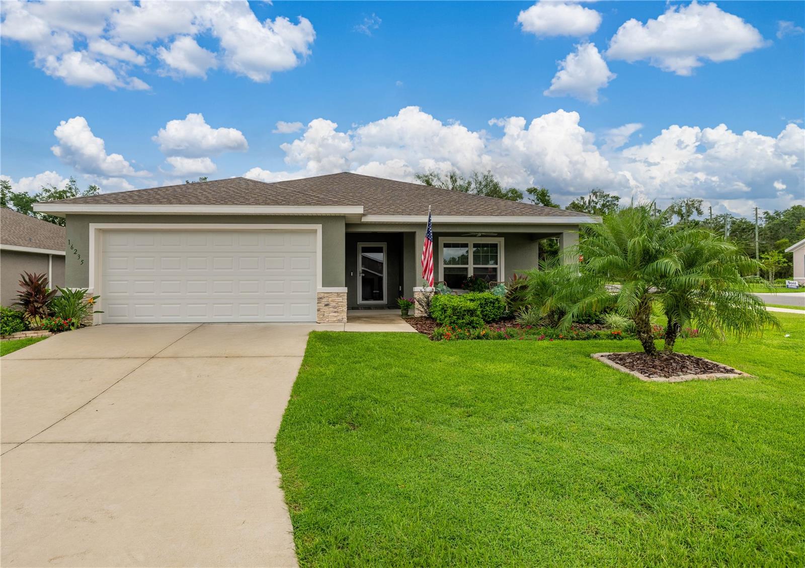 Welcome to this beautifully maintained, move-in ready home that was once the community’s model showcasing top-tier design and thoughtful upgrades throughout. Situated on a spacious corner lot with meticulously manicured landscaping, this 3 bedroom, 2 bathroom home offers exceptional curb appeal and standout features rarely found in today’s new construction. From the moment you enter, you'll notice the high-end finishes and thoughtful upgrades that set this home apart. All three bedrooms are exceptionally spacious, considerably larger than what you’ll find in most new construction with each being equipped with its own ceiling fan for added comfort. The open concept layout offers effortless flow from the bright, inviting living area to a modern kitchen designed for both function and entertaining. Out back, unwind in your screened-in lanai a true outdoor retreat that lets you enjoy peaceful mornings or relaxing evenings. The lush landscaping continues around the home, creating a serene and private backdrop. Additional features include a 2 car garage, built-in security system for peace of mind, and premium finishes throughout. Whether you're hosting guests or enjoying a quiet evening at home, this property offers both elegance and everyday ease. Don’t miss your chance to own a former model home that truly has it all space, style, and unbeatable curb appeal. Schedule your private showing today!
