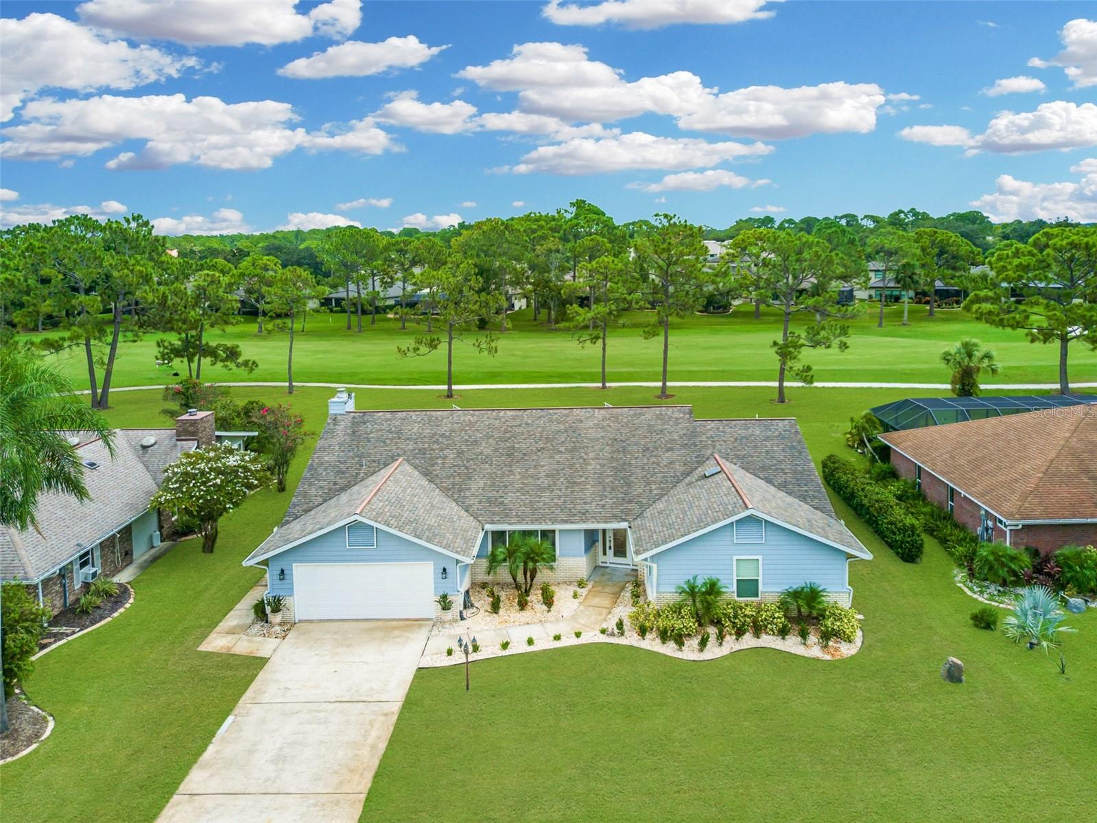 Location, quality craftsmanship and move-in ready living come together in this beautifully remodeled home situated on the 16th fairway in the premier gated community of Spruce Creek Fly-In. Originally upgraded for a family member, no expense was spared in the use of high-end materials throughout. The exceptional, open floor plan is bright and perfect for entertaining, offering two living areas, three bedrooms, three baths, a wood-burning fireplace, a flex area and an expansive eat-in kitchen with a massive quartz island, quality cabinetry, built-in pantry and full appliance package including washer and dryer. Additional features include an enclosed lanai, inside laundry with splash tub, outdoor shower, epoxy garage floor, tile flooring throughout designed to look like wood, remodeled baths, new windows, sliders, and doors (2018), roof (2016), hot water heater (2022), A/C system (2020), and a transferable termite bond. The 90x120 lot is not in a flood zone, and the seller is re-sodding certain sections of the front and back lawn for the new buyer. Virtually staged photos highlight the potential of this move-in-ready property, where nothing is left to do but bring your furniture. A short walk takes you to the country club, pool, fitness center, pro shop, golf, tennis, pickleball, taxiway and Fly-In Café. Spruce Creek Fly-In offers a unique aviation lifestyle centered around a private 4,000-foot runway with full-service FBO, along with resort-style amenities including an 18-hole golf course, social clubs, parks, trails, playgrounds and a community dock, all secured with 24/7 gated access and roving patrols, just minutes from Daytona Beach. Exceptional school system!