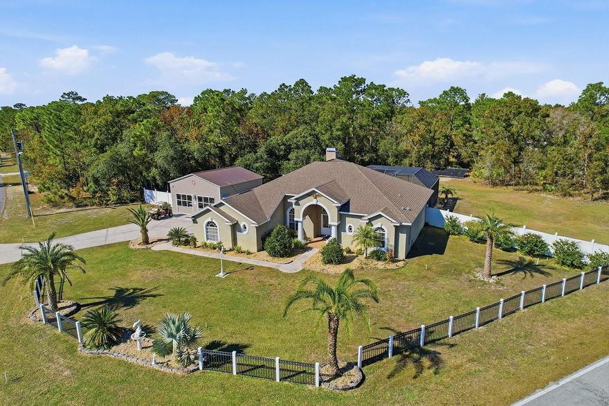 This magnificent custom estate offers a rare opportunity to own in Royal Highlands with 2500 SF of living space.  Nestled on 1.2 flat acres, CORNER LOT, complimented by NO HOA, NO CDD, and NO FLOOD INSURANCE required, X Flood zone.  With 4 bedrooms and 3 full baths individually servicing a triple split floor plan. One can be a In-Law suite with private entry. Enjoy a very generous size room encompassing the owner’s chambre en-suite and wardrobe dressing room for maximum privacy.  The residence provides a large open floor plan, formal dining room or office space, great room with high cathedral ceiling and beautiful wood burning fireplace all over looking the beautiful diamond-brite finish solar heated pool and hot tub 4 person spa area.  The spacious rich kitchen features granite counter tops and high end stainless steel appliances complete with NEW refrigerator and stove (2025) and walk in pantry.  Included in upgrades are NEW ROOF (2026), NEW pool pump (2025), NEW 25’x26’’ detached garage (2025) with two post car lift. Home is on a private well fed off the clear clean Weeki Wachee Springs aquifer.  The beautifully landscaped and fenced property features an 8 zoned automatic sprinkler system, abundant parking for RVs, boats, and all the toys.  Conveniently located just a couple miles from Weeki Wachee Mermaid attraction, beautiful Hernando Beach and boat launch park, and a wide array of shopping, dining, and medical facilities.  Five miles to the Suncoast Expressway for a quick trip to Tampa International Airport. Stabilization complete in 2010 and fully insurable.
