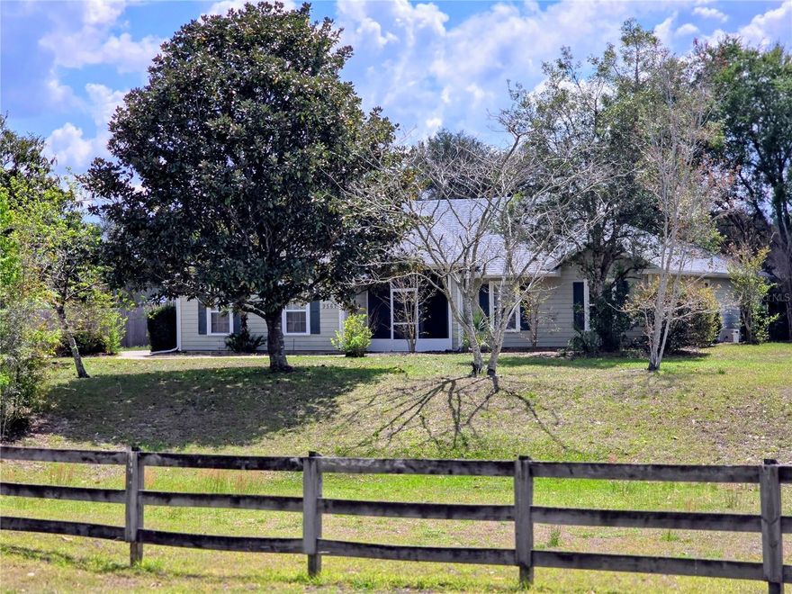 One or more photo(s) has been virtually staged. More photos coming soon! This location is a beautiful hidden gem of a neighborhood! Hammock Ridge III, where the homes are on at least 1 acre, hosting three board fencing aligning with the private paved roads and just enough street lighting for this charming neighborhood. Conveniently located minutes to I-75 and Archer Rd that offers all of the amenities this up-beat area invites you to see. Close to the University of Florida and Santa Fe College. Alachua County Fire Rescue Department, EMS is approximately ½ mile from this home. Approximately 15 minutes (more or less) to Haile Plantation Downtown Center, Town of Tioga and Jonesville. Other small outlying antiquity type towns are just a little bit longer scenic drive, oh and don’t forget our naturally fresh and cool clear springs! 
**This 2005 Built home has approximately 1,350 SF living space, open floor plan with vaulted and high ceilings. Freshly painted interior hosts luxuraury vinyl flooring and gorgeous plantation shutters in the centralized living area. The Spacious kitchen-dining combo has two pantry style cabinets; several other cabinets and lots counter space.
The owners’ suite, hosts plantation shutters, lighted trey/high ceiling, two closets, one is a walk-in. The attached bathroom also has plantation shutters, walk-in shower and high vanity. Two more bedrooms are nice sized with shelved closets. The guest/family bath features a tub/shower combo and high vanity. Two car side entry garage with laundry area, separate AC closet, ladder pulls down for the attic storage area. The front entryway is screened; the back porch is covered and open! This home is nestled on one landscaped acre and fenced on 3 sides. Magnolias, loquat, crape myrtle, dogwood, palms, oaks, azaleas and jasmine are just a few of the native plants and trees with lots of room for more! Underground utilities provided by Clay Electric, New roof, one year old HVAC, private well and septic system, water softener system and more! 
*Original Home Owner*Call for your private showing today, 24 hour notice please*  
“It’s a Great Place to Call Home”