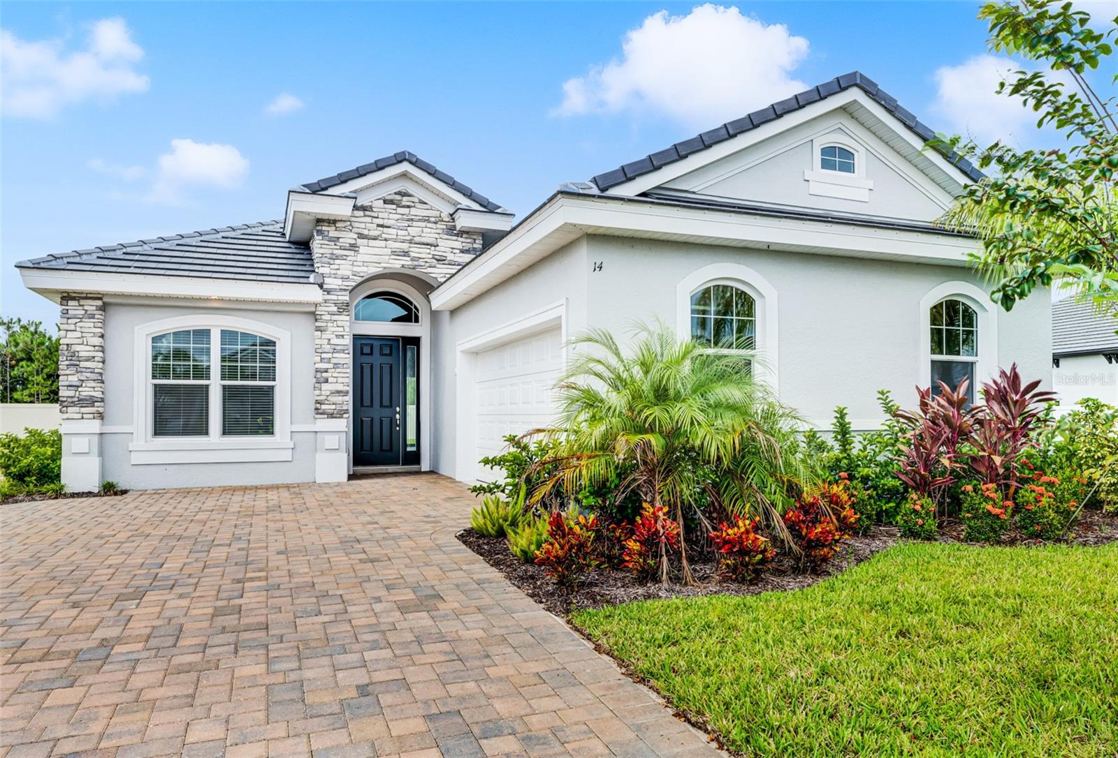 One or more photo(s) has been virtually staged. Welcome to your slice of a boating & luxury community paradise! ** Buy today for your chance to buy a 30', 40', or 50' deeded wet boat slip at a special price.** This exquisite Paytas Homes Monaco floor plan, situated in the picturesque Marina del Palma community of Palm Coast, is a 3-bedroom, 3-bathroom home, offering a spacious 2-car side-entry garage with beautiful brick paving for a large driveway to welcome your guests. Step inside to discover an inviting open layout, adorned with high ceilings and bathed in natural light, creating an airy ambiance throughout with ceiling fans in bedrooms and lanai. Fully outfitted with impact windows, the sliders from the primary and the living area allow additional living space on the 25x12 lanai and is ready for your outdoor kitchen with utility hook up all ready set. The electric fireplace and custom Wellborn soft-closing door cabinetry are just some of the special features you will find. Never lived in but includes a refrigerator and plenty of special lighting features, the home has a renewable one year termite bond and a state of the art Rain Bird system that has a wireless rain/freeze sensor. A generous walk-in closet and a luxurious en suite bathroom with a walk-in shower and dual vanity, gives plenty of additional space for your oasis. Need the same for another family member? The additional suite with its own private bathroom with walk-in shower has a connecting flex room with a tube skylight. The Paytas 10 year structural warranty is transferrable to new owner. See today and imagine your special touches living the Florida lifestyle that awaits you! The Marina del Palma community offers sidewalks, resort-style amenities (including a clubhouse & pool), secure boat storage for boats up to 30' in length, valet boat storage, a traditional marina, fitness center, dog park and more. Community entrance is across the street from Lehigh Trail Head for hiking and cycling and 3.9 miles to Flagler Beach beaches.