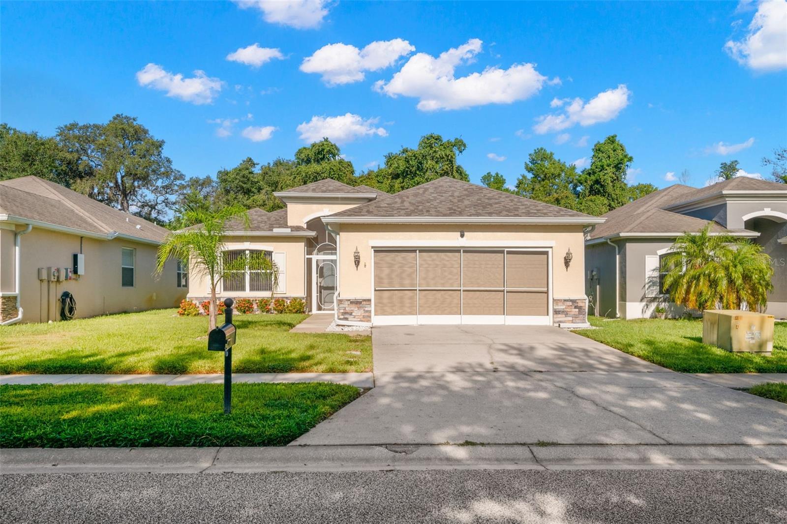 Welcome to Highlands — a desirable gated community in Hudson with a beautifully landscaped, elegant entry. This 3-bedroom, 2-bathroom 2 car garage Pioneer-built block home offers 1,979 sq. ft. of quality construction, thoughtful design, and upscale finishes. From the moment you step inside, you’ll notice the soaring 9-ft ceilings, premium trim package with elegant radius corners, and the warm beauty of upgraded Saltillo tile flooring — no carpet anywhere. The open-concept layout is perfect for everyday living and entertaining, with the spacious great room at the heart of the home flowing seamlessly into the dining area and well-appointed kitchen. Here you’ll find durable Corian countertops, custom tile work, and abundant cabinet space for storage. The formal dining room offers flexibility for hosting dinner parties or creating a home office, hobby space, or playroom. The private primary suite is a true retreat, featuring an upgraded ceramic-tile surround above the jetted tub, separate tiled shower (walls plus tile floor), dual-sink vanity, privacy door to toilet and a generous walk-in closet. Two additional bedrooms and a full guest bath are located on the opposite side of the home for comfort and privacy. Step outside to enjoy the custom rock façade, screened door on the oversized garage, an extended screened lanai and a peaceful backyard perfect for outdoor gatherings. Recent updates provide added peace of mind, including a new roof (2024), complete AC system change out (2020), and a 3-year-old water heater. Solid block construction, cast iron tub in main, and quality finishes speak to the craftsmanship of this home. This home has lots of electrical outlets and handicapped counter height and switches. Highlands offers secure gated entry and a prime location just minutes from shopping, dining, parks, and major commuter routes. Offered at $325,000 and complete with a home warranty, this move-in-ready property combines comfort, style, and location — the perfect place to call home.