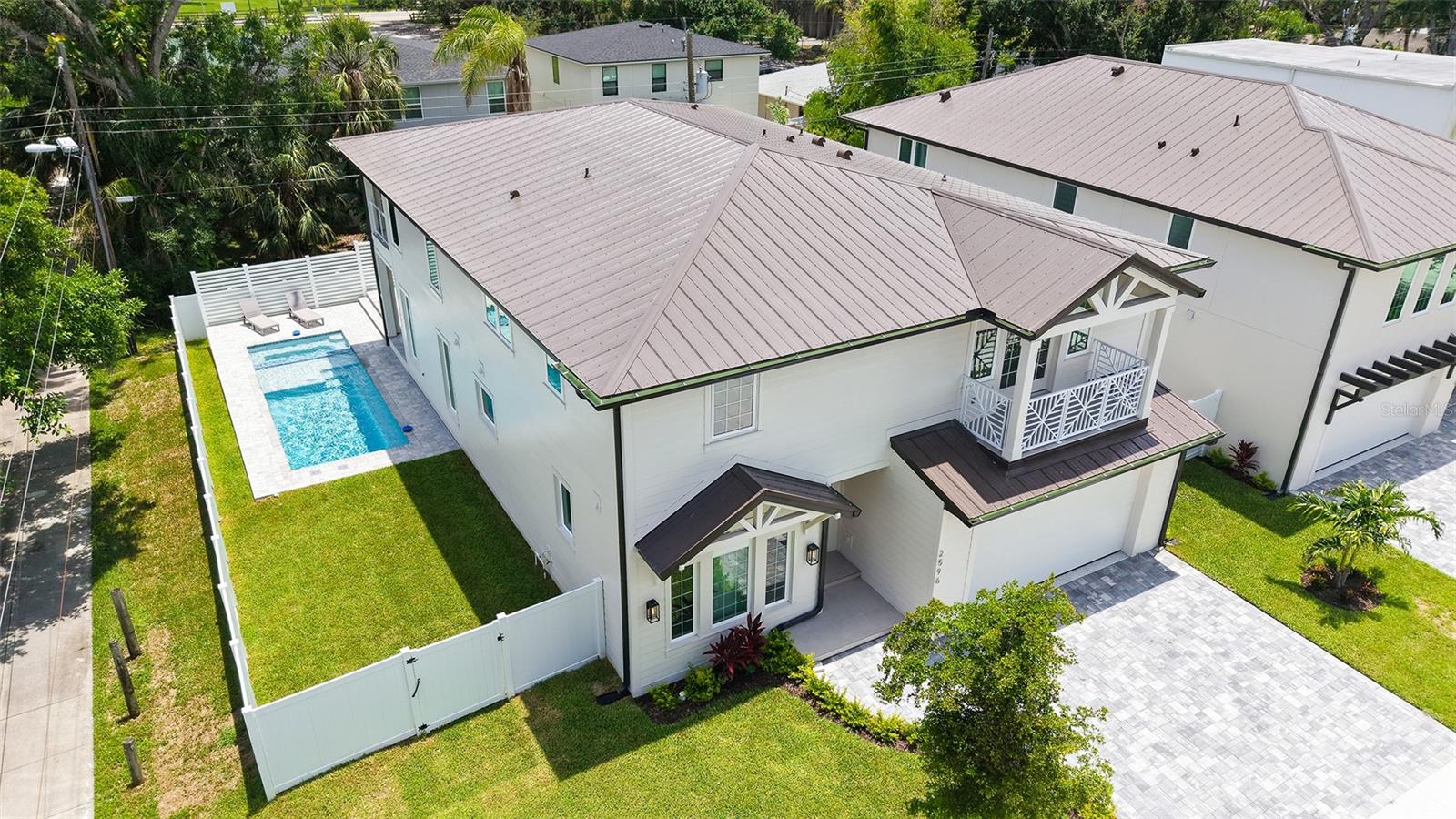 BRAND NEW 2025 – Seller is offering a $25,000 design credit and 10 free hours of consultation with an interior designer. Tucked away in Rustic Lodge, one of the most coveted corners of Arlington Park neighborhood, is just minutes from the energy & charm of downtown Sarasota. Enjoy a private outdoor sanctuary designed for elevated living. The heated saltwater pool and spa offers a resort-style escape, while the fully equipped outdoor kitchen — featuring a premium Blaze grill, granite countertops, and a sleek Zephyr beverage center — makes al fresco entertaining effortless. Beautifully laid pavers define the sophisticated space, and a generous green area adds a touch of tranquility — perfect for a garden, a game of fetch, or just lounging in the sun. Inside, large-format porcelain tile flooring creates a sleek and modern tone, flowing from the stylish foyer into a light-filled, open-concept living space designed for both comfort and sophistication. At the heart of the home lies a show-stopping chef’s kitchen, where floor-to-ceiling Studio Luxe custom cabinetry, quartz countertops, a full-slab backsplash, and a bold waterfall island deliver both elegance and functionality. The high-performance Thermador appliance suite — including a 42” French door refrigerator, induction cooktop, wall oven combo, and sleek range hood — brings professional-grade style to everyday cooking. Bonus cabinetry just off the kitchen adds a pop of style and extra storage while an oversized pantry holds all of your culinary essentials and keeps life feeling tidy. The built-in mudroom connects to the two-car garage that features a durable epoxy-coated floor. This home features four spacious bedrooms, each with its own ensuite bathroom and custom walk-in closet designed for effortless organization. The primary suite is thoughtfully located on the first floor for ultimate privacy and convenience, offering a luxurious walk-in closet and a spa-inspired bathroom with dual vanities, an oversized walk-in shower, and a freestanding soaking tub — the perfect place to unwind in comfort. Upstairs, you’ll find a bonus room and a large sitting area, giving you all the space you need for lounging, movie marathons, or game nights. Outdoor living is elevated with two beautiful balconies: a generous covered balcony along the entire width of the back of the home, and a quaint front-facing balcony on the second floor, ideal for quiet mornings or evening stargazing. Luxury details throughout include Kohler plumbing fixtures, Toto commodes, Daltile porcelain tile, Franklin Lighting, titanium pavers, premium PGT windows, PVC vinyl fencing, and a wind-resistant 5V crimp metal roof ready to take on the Florida elements in style. A 21-foot driveway, irrigation system, exterior lighting, and decorative shutters round out the curb appeal. Enjoy a one-year builder warranty, because in this home peace of mind pairs perfectly with luxury living. Located just minutes from downtown Sarasota, Siesta Key Beach, St. Armand's Circle, Sarasota Memorial Hospital, Legacy Trail, and top-rated schools, this property offers unmatched convenience. Plus, being within city limits means it qualifies for use as a vacation rental — making it a perfect choice for full-time living, a luxury retreat, or an investment opportunity. This is more than just a home — it’s a thoughtfully crafted lifestyle. Schedule your private tour today. Private financing available.