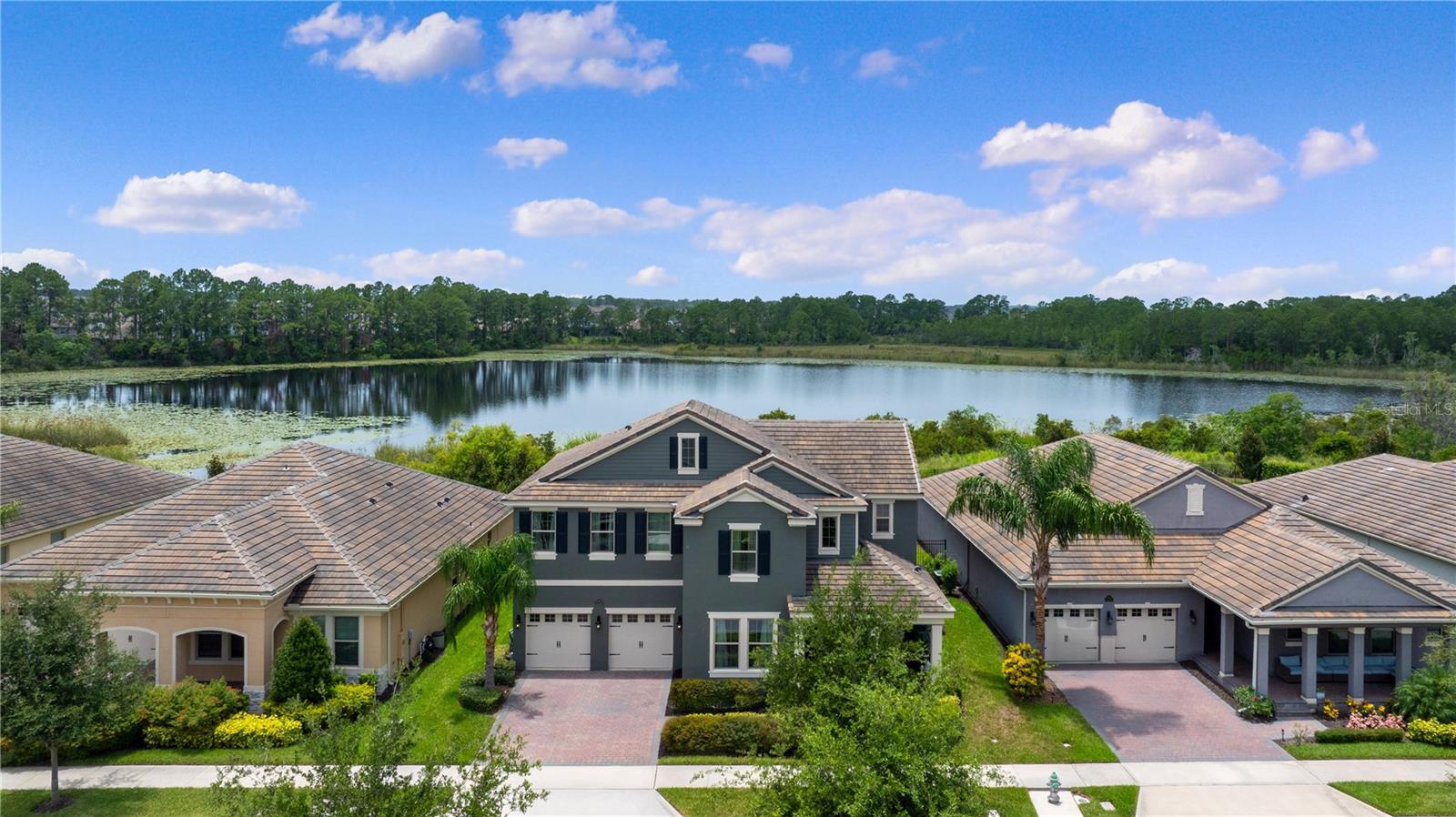 Welcome to 10180 Merrymeeting Bay Drive, a true gem nestled in the heart of Waterleigh—one of Winter Garden’s most sought-after communities. This stunning 5-bedroom, 3.5-bath Emerald Series home offers 3,910 square feet of beautifully upgraded living space, set on a premium lakefront lot overlooking the tranquil waters of Lake Tucker. From the moment you arrive, you’ll notice the elevated design touches that make this home so special—from the slate roof and extended lot to the pristine exterior, freshly painted in June, and its location on a quiet peninsula in Waterleigh’s picturesque Phase 2. Community amenities include, 3 pools, 2 clubhouses, multiple playgrounds, dog parks, outdoor workout areas, 2 indoor gyms, miniature golf course, tennis courts, beach volleyball court, community dock, walking paths, monthly classes and community events and the landscaping is included in the HOA.
Inside, the North Haven floor plan unfolds with elegance and thoughtful upgrades throughout. Premium flooring, custom cabinetry, wainscoting, and crown moulding add a level of refinement, while the open layout offers both comfort and functionality. The heart of the home seamlessly connects the living and dining spaces to the gourmet kitchen, creating the perfect setting for both relaxed living and entertaining. Just beyond, a spacious screened-in lanai invites you to enjoy breathtaking sunset views over the lake every evening. The heated saltwater pool and spa are controlled by a smart home automation system, and built-in speakers set the tone for unforgettable gatherings or peaceful mornings by the water.
This home was built to last, with block-on-block construction extending to the second floor—an upgrade rarely seen in this market—and additional insulation added for enhanced energy efficiency. Upstairs and down, every detail has been considered, including a thoughtfully plumbed laundry room ready for a utility sink, and an electric car charger in the garage for modern convenience. From its quiet, tucked-away street to the private, dockable lake it sits on, this home truly blends luxury with lifestyle in all the right ways.
If you’ve been looking for something extraordinary—something that offers both elegance and the essence of Florida living—this is your opportunity. Come experience all that 10180 Merrymeeting Bay Drive has to give. I’d love to show you around.