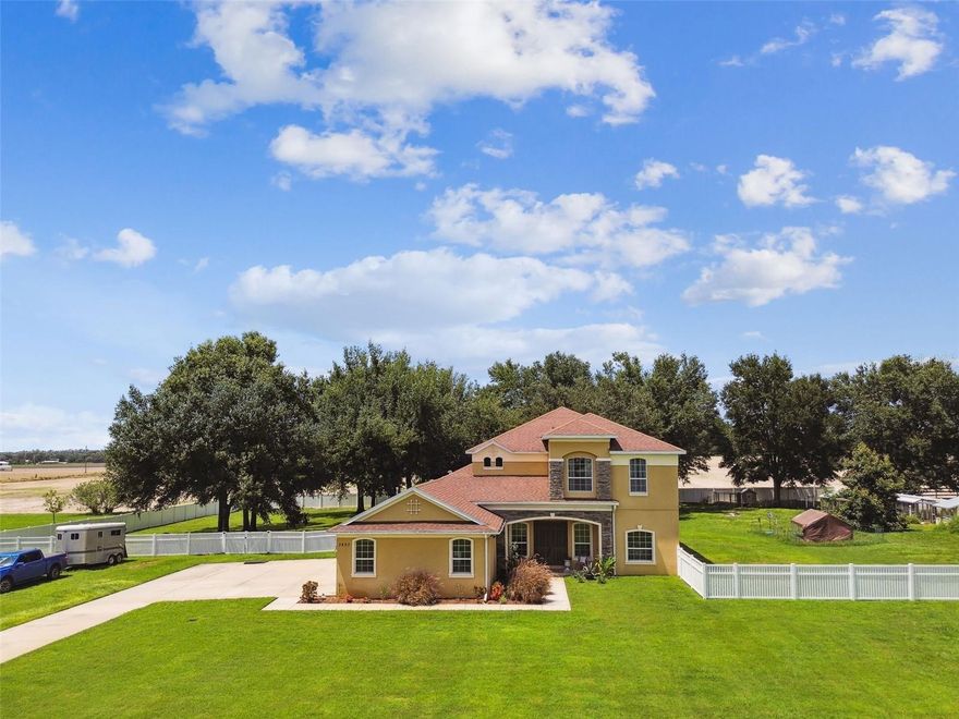 NO HOA, NO CDD - Nestled on a lush 1.6-acre parcel, this remarkable residence offers the ideal blend of sophistication, comfort, and functional design. With over 4,400 square feet of living space, this four-bedroom, three-bathroom, and two half-bath property is crafted for both everyday living and exceptional entertaining.
Upon arrival, guests are welcomed by double front doors that lead into a grand foyer, defined by soaring ceilings and elegant porcelain tile floors. The formal living room provides a refined atmosphere for hosting, while a thoughtfully placed half bath ensures convenience for visitors.
The expansive great room is the centerpiece of the home, filled with natural light from sliding doors that open to panoramic views of the fully fenced backyard. There is generous space for gatherings, recreation, and seamless flow to the kitchen, an entertainer’s dream.
The kitchen is a showcase of style and practicality, featuring granite countertops, a designer tile backsplash, stainless steel appliances, gas range with pot filler, beverage refrigerator, and rich dark cherry cabinetry. Adjacent to the kitchen, a separate dining room offers the perfect setting for memorable dinners and special occasions.
Downstairs, the mother-in-law suite is a standout feature, complete with private access, spacious bedroom, full bath, living area, and plumbing and wiring for a future kitchen and laundry. This suite is ideal for guests, multi-generational living, or as a private apartment.
Upstairs, the owner’s suite provides a luxurious retreat, including a spa-inspired bathroom with dual vanities, garden tub, and a grand double-entry walk-in shower. The oversized closet offers abundant space for wardrobe storage.
The secondary bedrooms are generously proportioned and strategically situated, each opening to a central media room equipped with a projector, perfect for movie nights, sports events, or relaxed family time. Every space is thoughtfully designed to provide both privacy and connection.
Outdoor living is fully realized with a screened lanai and open patio, perfect for morning coffee or evening gatherings. The expansive yard backs to tranquil farmland and features an avocado tree, with ample space to add a pool, store recreational equipment, or allow pets to roam.
Additional amenities include a three-car side-load garage and a spacious driveway, providing plenty of parking and storage. Located minutes from I-4, this estate offers easy access to downtown Tampa, Orlando, and local shops.
This exceptional estate is more than a home . It is a lifestyle destination. Whether entertaining, hosting family, or enjoying the serenity of the grounds, every detail is designed for comfort, enjoyment, and lasting memories