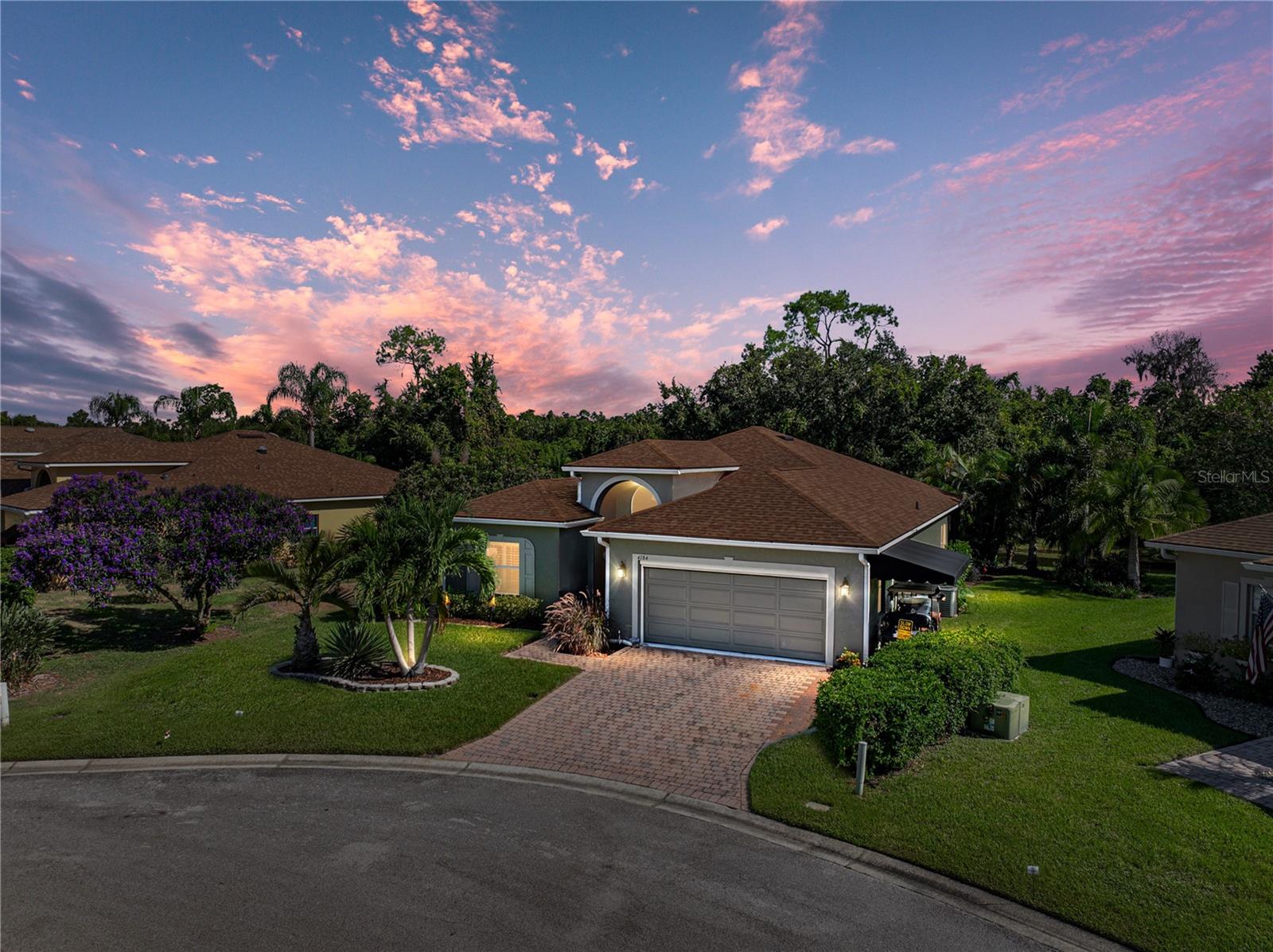 You don't want to miss out on this ready-to-move-in, well-maintained BISCAYNE floor plan home. This 3-bedroom, 2-bath open floor plan home features many special upgrades and updates. In addition to being located in a cul-de-sac, this home was built on a premium, oversized, and irregularly shaped pond-frontage lot with views of a nature preserve. Upon arrival, the curb appeal catches the eye. The quality landscaping has paver-defined beds with quality plantings, including stately palms. The paver walk, driveway, and fresh exterior paint (2025) add to the beauty of this home. The driveway has been widened and expanded to the south side of the home to accommodate a golf cart parking pad, which features an awning for protection. The covered front entry leads to the front door and the welcoming foyer. The foyer receives great natural light from the twin sidelights and a large, arched window over the transom. From the foyer, the openness of this floor plan becomes apparent. The combination of the living and dining rooms is the central focus of this home, around which the rest of the home revolves. The north wing features three bedrooms, while the south wing comprises the dinette, kitchen, laundry, and an attached two-car garage. The east wing features an expanded, covered, screened, and bird-caged lanai. The flexibility of the expansive combination dining and living room makes this the perfect home for entertaining. The living room has a ceiling fan and a triple slider that opens to the lanai. The 2nd bedroom is located at the front of the home and features a large reach-in closet, quality carpeting, a ceiling fan with light, and plantation shutters. The guest bath is conveniently located adjacent to the second bedroom and features a combination tub and shower with a ceramic tile surround, an elongated comfort-height stool, and a vanity with a cultured marble top. The linen closet is in the connecting hall. The third bedroom is accessed by a double door off the living room and features quality carpeting, a ceiling fan with light, and two closets. The primary suite features a spacious bedroom with carpeting, a ceiling fan with a light, a double window, and a double door to separate the bedroom from the bathroom. The primary bath features twin vanities (one elevated) with cultured marble tops, a corner garden tub, two walk-in closets, and a privacy area equipped with an elongated comfort-height stool and a large stall shower with a glass shower door and grab bars. The kitchen features granite counters, upgraded stainless steel appliances, including a French door refrigerator with ice and water dispensers, ample cabinetry, a closet pantry, and a snack bar. The dinette is adjacent and has a double slider to the lanai. The living room, dining room, dinette, and kitchen feature newer luxury vinyl wood-look plank flooring. The inside utility room doubles as the laundry room and the mud room for the attached 2-car garage. The laundry room has a utility sink. The washer and dryer stay. The attached 2-car garage has a new powered roll-up privacy screen, opener, pull-down attic ladder, service door, and window. The rear of the home features an expanded, covered, screened, and bird-caged lanai that boasts paver flooring, two ceiling fans, and access to a small, open patio. The view from the lanai is unparalleled. The roof was replaced in 2022. The entire interior has been recently painted. Updates are throughout. A Lake Ashton Golf Club community gem!