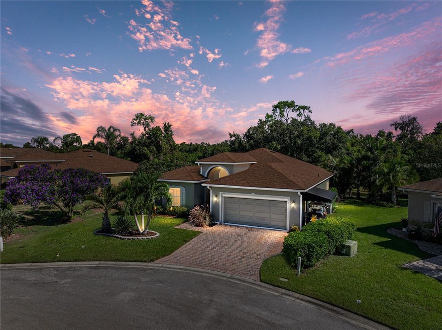 You don't want to miss out on this ready-to-move-in, well-maintained BISCAYNE floor plan home. This 3-bedroom, 2-bath open floor plan home features many special upgrades and updates. In addition to being located in a cul-de-sac, this home was built on a premium, oversized, and irregularly shaped pond-frontage lot with views of a nature preserve. Upon arrival, the curb appeal catches the eye. The quality landscaping has paver-defined beds with quality plantings, including stately palms. The paver walk, driveway, and fresh exterior paint (2025) add to the beauty of this home. The driveway has been widened and expanded to the south side of the home to accommodate a golf cart parking pad, which features an awning for protection. The covered front entry leads to the front door and the welcoming foyer. The foyer receives great natural light from the twin sidelights and a large, arched window over the transom. From the foyer, the openness of this floor plan becomes apparent. The combination of the living and dining rooms is the central focus of this home, around which the rest of the home revolves. The north wing features three bedrooms, while the south wing comprises the dinette, kitchen, laundry, and an attached two-car garage. The east wing features an expanded, covered, screened, and bird-caged lanai. The flexibility of the expansive combination dining and living room makes this the perfect home for entertaining. The living room has a ceiling fan and a triple slider that opens to the lanai. The 2nd bedroom is located at the front of the home and features a large reach-in closet, quality carpeting, a ceiling fan with light, and plantation shutters. The guest bath is conveniently located adjacent to the second bedroom and features a combination tub and shower with a ceramic tile surround, an elongated comfort-height stool, and a vanity with a cultured marble top. The linen closet is in the connecting hall.  The third bedroom is accessed by a double door off the living room and features quality carpeting, a ceiling fan with light, and two closets. The primary suite features a spacious bedroom with carpeting, a ceiling fan with a light, a double window, and a double door to separate the bedroom from the bathroom. The primary bath features twin vanities (one elevated) with cultured marble tops, a corner garden tub, two walk-in closets, and a privacy area equipped with an elongated comfort-height stool and a large stall shower with a glass shower door and grab bars. The kitchen features granite counters, upgraded stainless steel appliances, including a French door refrigerator with ice and water dispensers, ample cabinetry, a closet pantry, and a snack bar. The dinette is adjacent and has a double slider to the lanai. The living room, dining room, dinette, and kitchen feature newer luxury vinyl wood-look plank flooring. The inside utility room doubles as the laundry room and the mud room for the attached 2-car garage. The laundry room has a utility sink. The washer and dryer stay. The attached 2-car garage has a new powered roll-up privacy screen, opener, pull-down attic ladder, service door, and window. The rear of the home features an expanded, covered, screened, and bird-caged lanai that boasts paver flooring, two ceiling fans, and access to a small, open patio. The view from the lanai is unparalleled. The roof was replaced in 2022. The entire interior has been recently painted. Updates are throughout. A Lake Ashton Golf Club community gem!