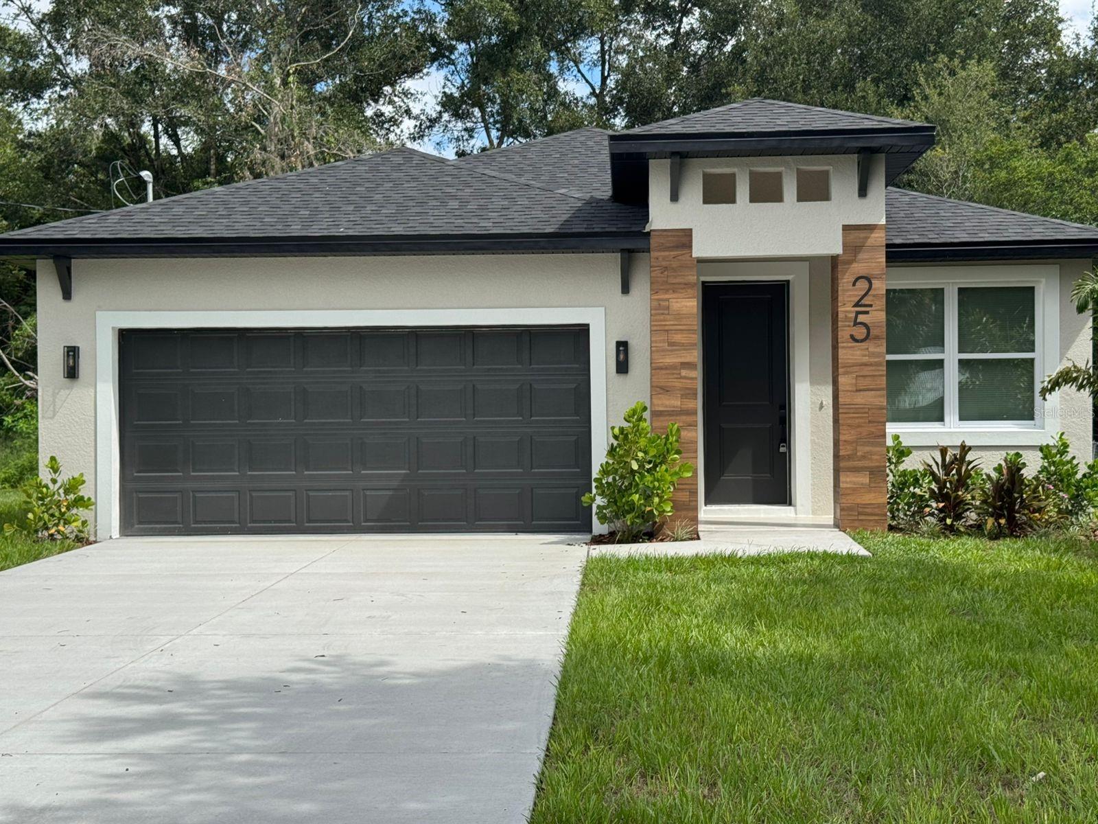 One or more photo(s) has been virtually staged. This stunning BRAND NEW CONSTRUCTION features 4 bedrooms, 2 bathrooms, one half bathroom and a two car garage. The gourmet kitchen is a chef's delight, featuring upgraded quartz countertops and brand-new stainless steel appliances ready to inspire your culinary creations. Throughout the home, you'll enjoy beautiful, low-maintenance flooring—no carpet in sight! The open concept seamlessly unites the kitchen, dining, and living areas, making it ideal for entertaining. Outside, the expansive driveway offers ample parking for multiple vehicles or visiting guests. The spacious backyard invites endless possibilities, whether it’s gardening, grilling, or simply soaking up the Florida sunshine. This home places you close to schools, shopping, dining, and local amenities. Don’t miss your chance to own this exceptional property. Schedule your viewing today and experience the beauty and comfort of this remarkable new construction home!