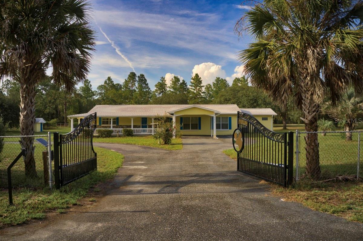 Discover the perfect blend of privacy, comfort, and outdoor living in this beautifully maintained 4-bedroom, 2-bathroom home with 1,853 sq. ft. of living space on just under 7 acres.
The home features a new roof (2024), fresh exterior paint, dual-zone A/C with two units, upgraded windows, and plantation shutters throughout. Inside, you’ll find a thoughtfully designed layout with no carpet—low-maintenance flooring and abundant storage, including a large laundry room and double walk-in closets in the master suite. The primary bathroom offers a large jetted garden tub, double vanity, and separate walk-in shower for a true retreat.
Outdoor living shines here, starting with a welcoming circular driveway, large front porch, mature landscaping with palms, crepe myrtles, and evergreens, plus well water—no water bill to worry about. The spacious enclosed back patio with double ceiling fans overlooks the sprawling natural acreage, perfect for enjoying morning coffee or evening sunsets. No neighbors on three sides of the property.
The property sits on two fully fenced and cleared acres, secured with an automatic solar-powered double gate, plus five additional natural acres for a total of nearly 7 acres. Wildlife enthusiasts will love the deer, fox squirrels, gopher tortoises, and birds that frequent the property.
A highlight is the massive 40' x 60' detached workshop/garage/RV barn with three bays and a large upstairs loft—ideal for hobbies, storage, or business needs.
Located in Rainbow Lakes Estates, residents enjoy access to two lakes in the neighborhood, a fitness center, community center, playgrounds, and parks. Just 5 miles from the beautiful Rainbow River, with the Gulf of Mexico and Goethe State Forest nearby, endless outdoor recreation awaits.
If you’ve been searching for room to roam, peaceful surroundings, and space for all your hobbies and toys, this property is a must-see!