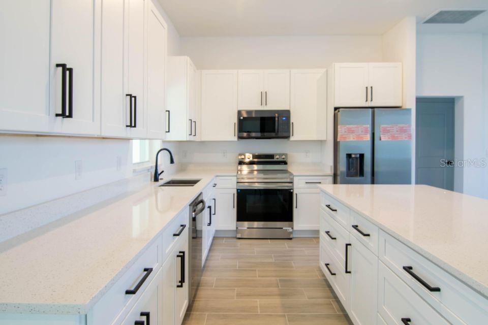 One or more photo(s) has been virtually staged. Don't miss the opportunity for long-term rental. 4BR/2BA Single Family Home in Port Charlotte ?? This charming residence offers spacious, sun-filled living areas perfect for relaxation and entertaining. The kitchen is a chef's dream with sleek wh.ite countertops, an island, and modern appliances. Step outside to a peaceful, lush yard, providing a serene escape. You may rent this property furnished or unfurnished. Ideally located just minutes from Gasparilla Road, enjoy the perfect balance of tranquility and convenience. Apply now!