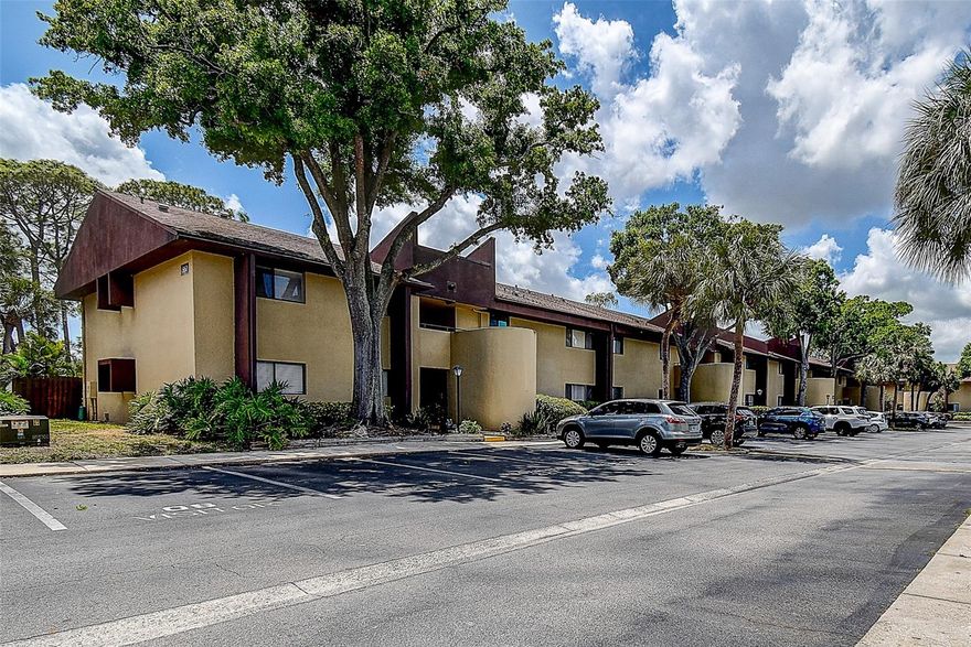 Don't miss your opportunity to own a spacious 3BR/2BA ground-floor condo in the highly desirable Village Lake Community. This move-in-ready home features an open floor plan, fresh interior paint, new carpet, and abundant storage throughout. Large eat-in kitchen with pantry and washer & dryer in the unit for added convenience. Sliding glass doors lead to a private screened and enclosed porch with storage closet, overlooking a mature, beautifully landscaped private backyard—perfect for relaxing or enjoying morning coffee. The primary suite offers an en-suite bath, walk-in closet, and serene garden views. The second bedroom also features garden views. Includes assigned parking plus ample guest parking. Community amenities include pool, tennis courts, playground, clubhouse, and walking paths. Condo fee includes water, sewer, trash, internet, and ground maintenance. Ideally located near I-275, downtown St. Petersburg, Tampa via Gandy Bridge, Tampa International & St. Pete–Clearwater Airports, award-winning beaches, and walking distance to shopping, and pharmacy,  restaurants.