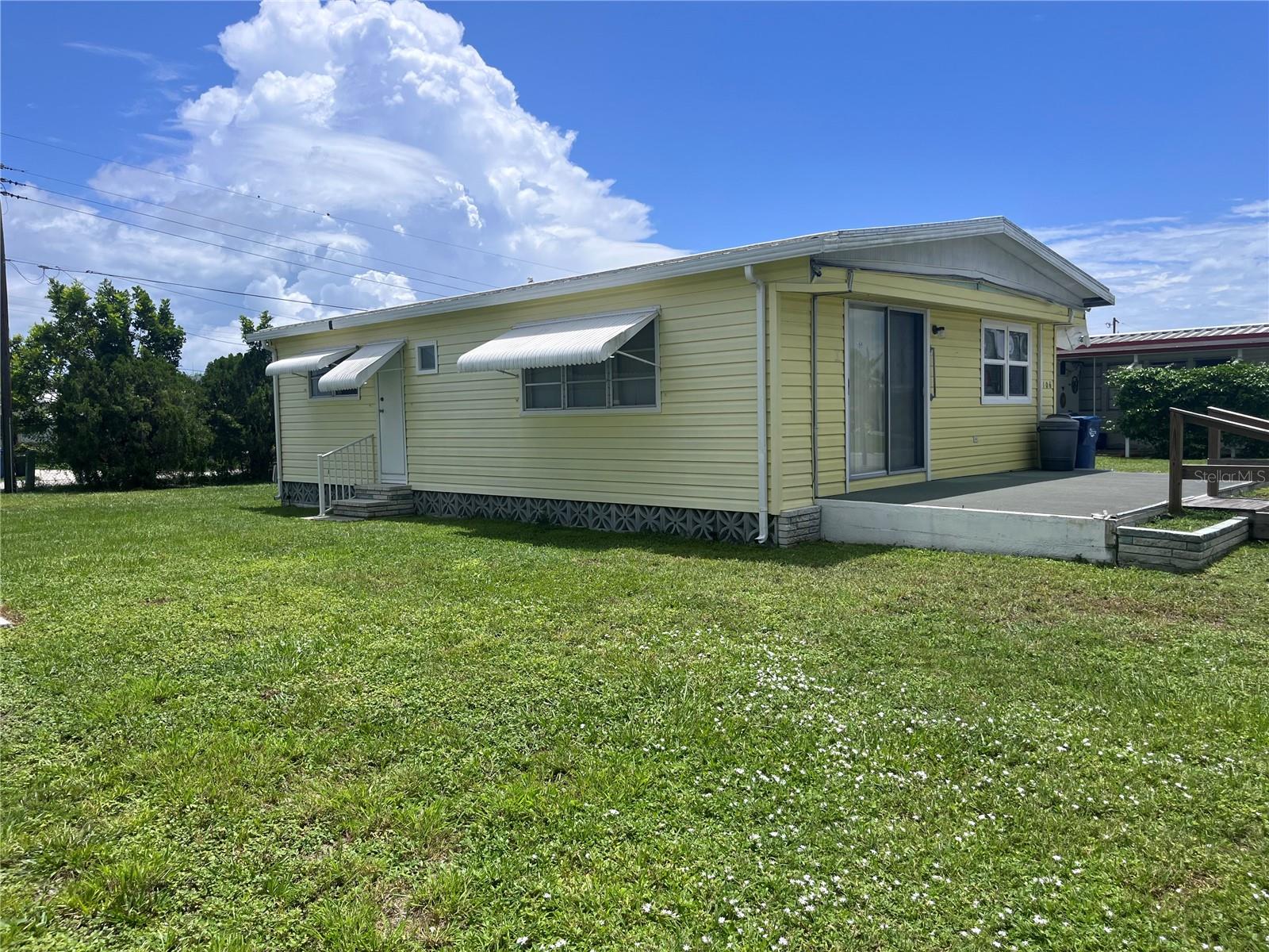 Come see this cheery yellow home, and enjoy sunny Florida living everyday. Heather Hills Estates is a 55+ community, with low association fees. The community offers tree lined roads, many palms, a clubhouse to gather with neighbors. Pot lucks, and entertainment. There is an optional nominal fee of $50 each year for the private social events at the club house. The mailbox is located outside the clubhouse near the large green space, with lots of shade, and picnic tables. This home has been well taken care of and is located 1 home from the end of the road, a nice and quiet corner in the park. Some of the plus features include an easy to maintain good size yard, roof year is 2022 (with a transferable warranty to the new owner.) AC 2022, some large appliances purchased new last year. Lots of storage inside. There are 3 closets in the 1st Bedroom. The listing price reflects the exterior changes since Hurricane Milton. (The previous carport, storage, and front lanai no longer exist on the north and west side.) Move in and make this home your own....add some shade, exterior storage, new screen to the front porch and more for ultimate outside enjoyment! Lots of possibilities and very affordable. Heather Hills is pet friendly, golf cart friendly, and boat okay too. Owners may rent their home too, must be 55+.