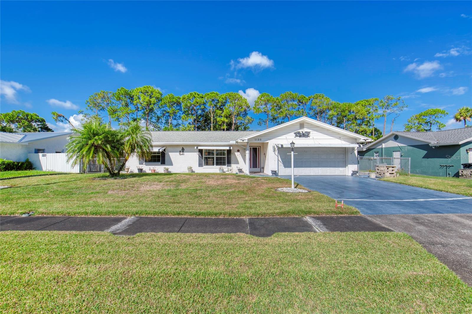 Centrally located in Port Orange, on a quiet street with easy access to shopping, schools, parks and more……..This 2 bedroom 2 bathroom home has all the potential for those looking to downsize or the new family starting out. Home also offers a glass enclosed rear porch and an oversized 2 car garage with work benches built in. All the big ticket items look to be in great shape so with a few cosmetic updates this could be your piece of paradise. Call today for an easy showing! Square footage received from tax rolls. All information recorded in the MLS intended to be accurate but cannot be guaranteed.