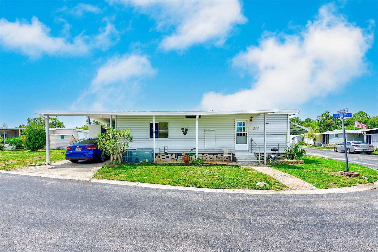 Tucked inside the lively and welcoming pet-friendly 55+ community of Clearwater Cascade, this beautifully updated manufactured home INCLUDES the land share (valued at $55,000!) and offers a blend of comfort, style, and convenience. With ZERO hurricane flooding and a NON-Flood Zone location, this home boasts 840 square feet of thoughtfully designed, open and airy living space, plus an additional 171 "bonus" square feet (leveled AND centrally air-conditioned!), giving you peace of mind and plenty of room to relax and entertain. Inside this refreshing Florida home, you’ll find BRAND NEW sub-flooring and modern laminate flooring that flows seamlessly throughout, complemented by fresh interior paint for a clean, airy feel. The kitchen is equipped with ALL-NEW stainless steel appliances and BRAND NEW GRANITE countertops & matching granite backsplash, making meal prep easy and enjoyable. Additionally, both bathrooms have been tastefully remodeled with updated vanities and toilets, as well as beautiful wainscoting in the guest bathroom, offering a fresh and polished look. Enjoy the indoor breezeway/workshop that leads to your laundry & storage area- washer & dryer included! Beyond the home itself, the Clearwater Cascade community is filled with energy and liveliness, featuring social opportunities such as clubs, leagues, and dances, as well as wonderful amenities like TWO heated community pools, saunas, hot tub, a kayak/canoe ramp, and clubhouse with fitness center, library, shuffleboard, and bocce ball courts. The low monthly HOA fee of only $353 is enticing, especially since it INCLUDES cable & internet, water, sewer, trash, and lawn maintenance! Whether you're enjoying a quiet afternoon at home or heading out for shopping, dining, or entertainment, you'll love this location in the heart of Pinellas Park, which also lies just minutes from downtown St. Petersburg, Clearwater, our award-winning beaches, two major airports, and everything our beautiful area has to offer. Don't miss this opportunity- the Florida lifestyle is calling your name!
