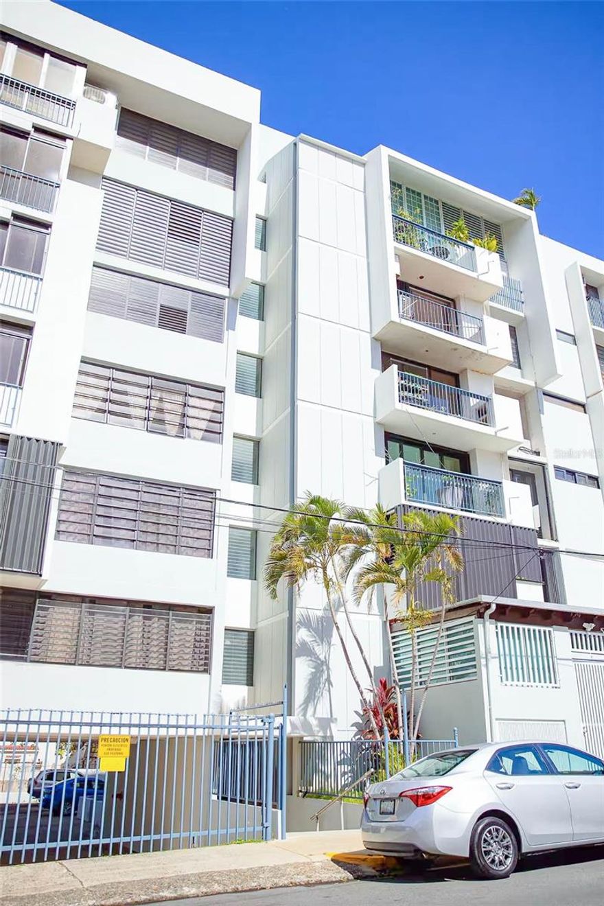 This fully renovated three-bedroom, two-bathroom condo is located in the heart of Miramar, San Juan, within a gated building that offers private and secure assigned parking. The spacious condo is fully furnished with one king bedroom and two queen bedrooms, its open-concept layout features a dining area for six, a comfortable sectional with a Smart TV, and a fully equipped kitchen with modern appliances and extra seating on quartz counter top peninsula. All bedrooms have a/c inverter split units. All windows have treatments, the bedrooms have blackout curtains in addition. All bedrooms have built- in closets. The balcony features an electric grill. Additional features include a washer and dryer in the unit. Location! Walking distance from Laguna del Condado and beach (1km), Escambron Beach (1.7km), Convention Center, Distrito T-Mobile (1.6 km), restaurants (500 m), cafés (400 m), and entertainment options such as theater (650 m). Miramar is one of San Juan’s most desirable neighborhoods.