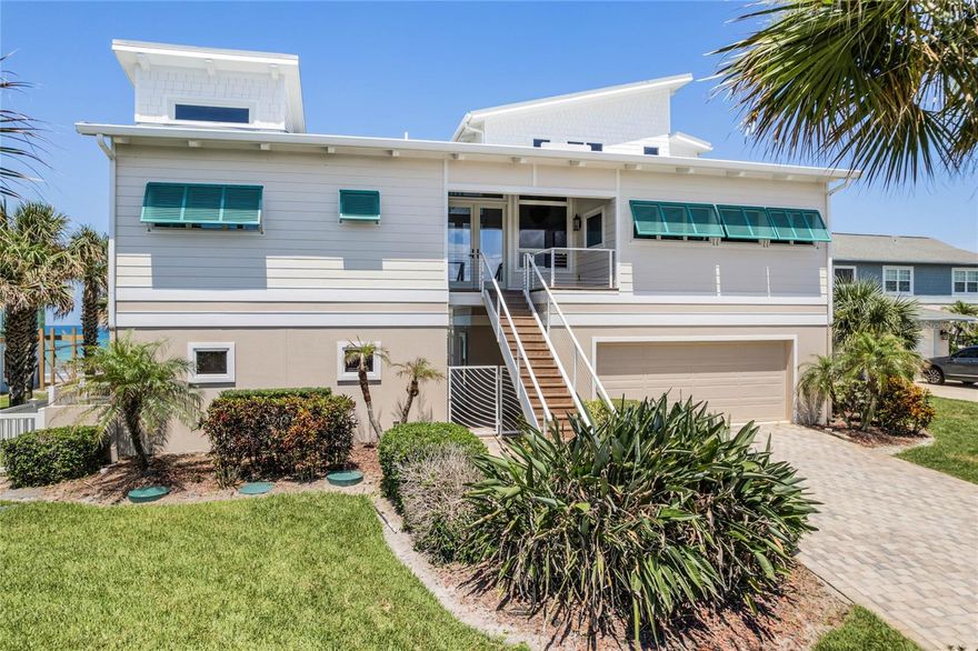 BRAND NEW SEAWALL UNDERWAY! Stunning ocean views, a spacious floor plan, and designer touches throughout make this coastal residence the perfect place to call home. This 4 bedroom, 3 full bathroom and 2 half bathroom oceanfront pool home in New Smyrna Beach is located on the prestigious Van Kleeck Dr. The property offers direct beach access and breathtaking ocean views from every floor. Surrounded by professionally landscaped grounds, the outdoor area features a beautifully designed saltwater pool, complemented by a spacious travertine deck, a half bath, and outdoor shower for convenience. Off the pool is a large, conditioned fun/flex room with desirable pecky cypress moulding, mini-fridge, icemaker with a full wet bar. Inside, 2nd level living accessible by elevator, welcomes your guests through a vaulted foyer surrounded by floor to ceiling Anderson windows/doors. This leads to the open floor plan hosting a spacious living room/dining room with mahogany built-ins, gas fireplace, and an expansive wrap-around deck flowing from all rooms to take in the views. The custom kitchen includes hand-selected stone counters, stainless steel appliances, induction cooktop, trash compactor, and solid wood cabinets with mahogany finish. Matching custom stone adorns the wet bar with a copper sink off the dining room, while behind the kitchen is an extensive storage corridor with custom pull-outs, quartz countertops, wall-mounted microwave/wall oven/warming drawer combination, and large walk-in pantry. Enjoy ocean views from the separated junior suite with en-suite full bath on this level, along with a separate half bath for guests off the foyer. Also on this level, a large private office with built-in cabinetry provides two desks, drawers, built-in shelves, and quartz countertops. The 3rd level is a private oasis where the primary suite encompasses the entire floor totaling 1150 sq ft. The spacious bedroom enjoys tons of natural light, a vaulted ceiling, and a large private balcony overlooking the ocean. Also on this level, is a large closet, dual vanity bathroom, standalone shower, jacuzzi tub, and separate wc. The 1st floor features two bedrooms with direct ocean views that flow to the oceanfront patio. This level also boasts a full bathroom with a shower and dual vanities, a large walk-in laundry room, a flex space, 2 car garage, storage galore, and elevator access to the second level. Soaring ceilings and natural light ensures unparalleled views from every floor and nearly every room. Artistic touches throughout including murals, imported light fixtures, and custom hardware/finishes show the attention to detail in this home. This, along with its fantastic location, deem it truly one of a kind. Contact us today to see!