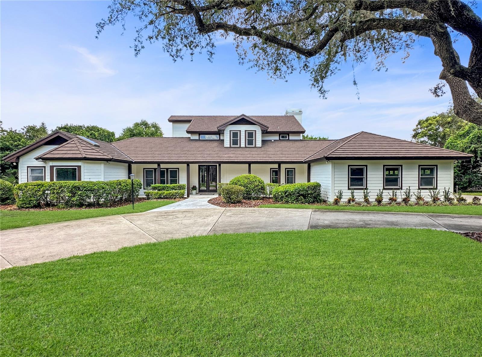 Under contract-accepting backup offers. Modern Elegance Meets Timeless Charm in this Exquisitely Renovated Pool Home in Heathrow. Welcome to 1436 Shadwell Circle — an impeccably updated two-story estate nestled in the exclusive guard-gated golf community of Heathrow. Located in the East Camden enclave of prestigious homes, and set on a lushly landscaped lot with mature trees and complete privacy, this striking home offers the perfect blend of luxury, space, and sophistication.
Boasting 4 bedrooms, 4 full bathrooms and a half bath, and over 3,700 square feet of beautifully redesigned living space, this residence impresses from the moment you arrive. The circular driveway leads to a fresh modern exterior with a large front porch, clean lines, a stone-coated metal roof, and manicured landscaping.
Inside, natural light floods the expansive open layout, enhanced by soaring ceilings, wide-plank wood-look tile floors, and elegant wrought-iron railings. The gourmet chef’s kitchen is a true showstopper—featuring soft sage custom cabinetry, Magnolia quartz countertops and backsplash, premium double ovens and cooktop, and designer pendant lighting. A large island and 2 end bars add an upscale touch, perfect for entertaining.
The spacious family and dining rooms center around a custom stone fireplace, custom cabinetry with a wet bar and wine fridge, and overlook the sparkling pool through a wall of French doors leading out to 2 large sceened in patios, creating an effortless indoor-outdoor flow.
Retreat to the lavish primary suite, where a spa-like bath awaits with dual vanities, a freestanding soaking tub, and an oversized walk-through shower with dual rainfall heads, all finished with designer tile and custom cabinetry. Additional primary suite features include a large walk-in closet and private porch.
Outdoors, the private backyard is a serene oasis with a large resurfaced pool, expansive patio with travertine tile, and lush greenery—ideal for entertaining or relaxing in quiet seclusion.
Additional highlights include:
A grand foyer and dramatic staircase,
Guest suite or office on the main level,
Generous secondary bedrooms with updated baths,
Large laundry room with custom cabinetry,
Oversized 3-car garage,
A large sundeck balcony with spiral staircase down to pool deck,
Zoned for top-rated Seminole County schools.
Set within one of Central Florida’s most desirable golf communities, with access to The Country Club and world-class amenities, this is more than a home—it’s a lifestyle.