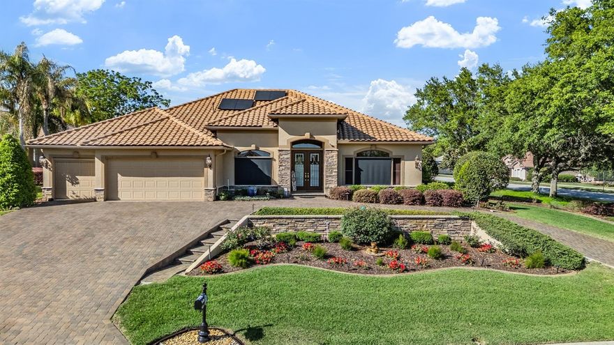 HIDDEN GEM in the HILLS of East Pasco, where you can Experience refined luxury living in this exceptional, custom-designed “Bonaire” residence by Arthur Rutenberg, ideally positioned on a beautifully landscaped, elevated corner homesite within the prestigious Lake Jovita Golf & Country Club. Perfectly situated just moments from the clubhouse, this exquisite 3042 sf home captures sweeping views of the putting green and driving range from its expansive lanai, creating a serene and picturesque backdrop for everyday living and casual elegant entertaining. Meticulously maintained by its original owners, this residence showcases superior craftsmanship and an impressive array of high-end upgrades. The thoughtfully designed split floorplan offers both comfort and privacy on each wing, featuring a sophisticated den/study, as well as a versatile office, utility and hobby room complete with extensive custom cabinets, desk-height workspace, and a built-in stowaway worktable. The primary suite is a true owners retreat, highlighted by an extraordinary oversized DIVINE dressing room with custom shelving, organization systems, automatic lighting and a large window for natural light! Gourmet kitchen is the HUB of the home with a rounded island overlooking the family room with sliders to the outdoor living space. The expansive screened lanai boasts an oversized covered area with dual circulating fans, a custom saltwater pool with water feature & Lanai and pool lighting systems, therapeutic spa, outdoor shower and a fully equipped outdoor kitchen featuring a grill, pot burner, wine chiller, and sink—perfect for hosting on any scale. Enhancing the experience, American Flag & flagpole, all lanai furnishings & four mounted TVs are included, creating a turnkey outdoor OASIS! This home is as efficient as it is elegant, featuring a new Tile Roof (2023), solar panel system (2023) offering remarkably low average electric bills with potential annual rebates, pool heater (2020), whole-house generator, buried propane tank, irrigation well and underground drainage systems. Hurricane shutters and screens provide peace of mind, while modern conveniences such as Cat-5 wiring, centralized electronics hubs, surround sound, LED lighting and solar sky tubes ensure a connected and light-filled environment. Additional luxury touches include circular paver driveway, updated bathrooms with quartz finishes and spa-like features, designer window treatments, luxury vinyl woodgrain look floors & stunning landscape with architectural lighting that elevate the homes ambiance both day & night. Stunning curb appeal with terraced floral landscaped beds welcomes family & friends. Set within one of the area’s most sought-after Security guard-gated communities, residents enjoy access to scenic walking paths, park with playground, picnic area, 2 dog parks, pickleball, tennis & basketball, and walking trail with fitness stations. OPTIONAL MEMBERSHIPS at the CLUB available to add Fitness center, 2 championship golf courses, Har-tru clay tennis courts, Jr Olympic swimming pool with lap lanes, social events for members, pro shop and full service restaurant—all while being conveniently located near shopping, dining, medical facilities, and major highways with easy access to Wesley Chapel, Tampa, St Petersburg and Orlando.  This is a rare opportunity to own a truly distinguished property that blends luxury, efficiency, and lifestyle in one remarkable residence... what a GREAT PLACE to call HOME!