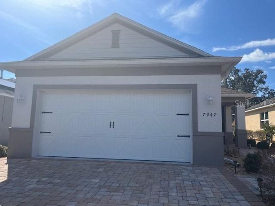 Unfurnished and move-in ready, this beautiful Oren home in On Top of the World's Indigo East features 2 bedrooms, 2 bathrooms, and a 2-car garage, with upgrades throughout. The kitchen includes stainless steel appliances and a dining area, while tile flooring extends throughout the home. The split floor plan offers privacy for guests, with the second bedroom and guest bath at the front, complete with quartz countertops and a tub/shower. The primary suite features a walk-in closet with custom shelving, and an ensuite bathroom with a barn door, double vanity with quartz counters, and a walk-in shower with glass door and bench. Enjoy the screened lanai, open paver patio, stone landscaping, and garden. Additional features include epoxy garage floors with built-in shelving, tinted windows, and a widened paver driveway. Walking distance to the fitness center and pool, this home includes access to community amenities, with a Gateway pass available for purchase to access all of the OTOW Central features. Available now with a minimum 1-year lease at $1,900 per month plus utilities. Pet-friendly! (Property ID 0417AINDS)