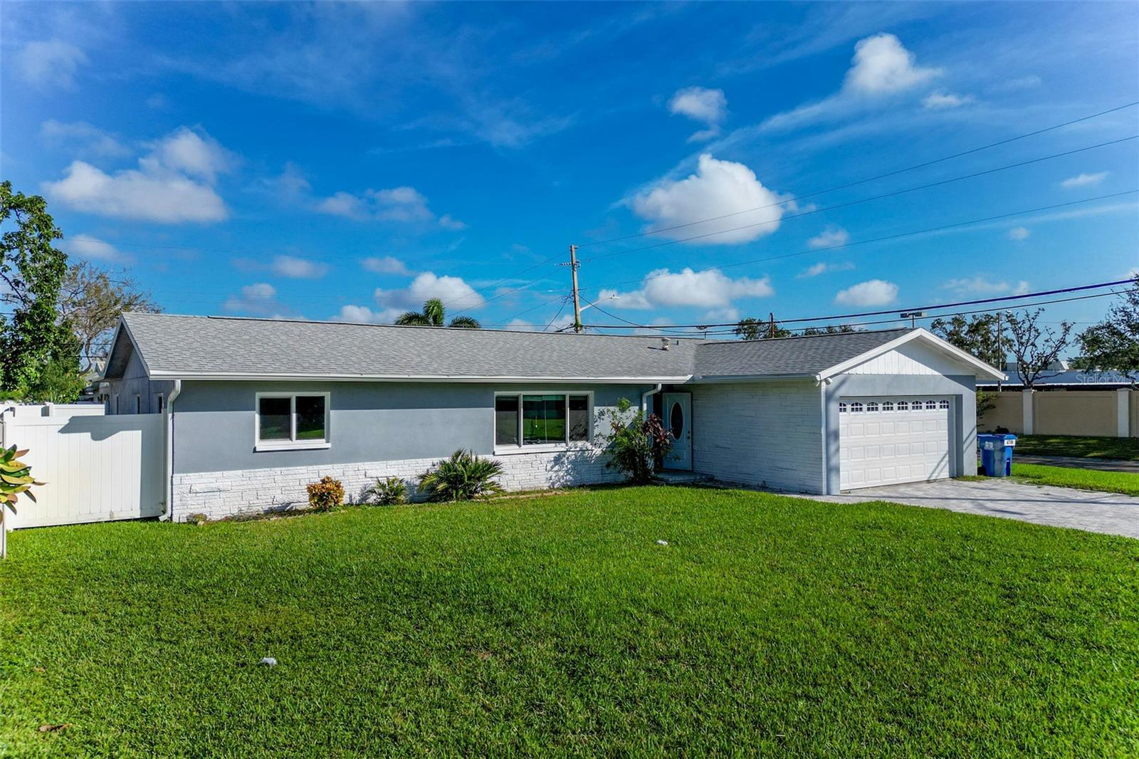 MOTIVATED SELLER! MOVE-IN READY 4 BED / 2 BATH CORNER LOT HOME IN HIGHLY DESIRABLE CROSSROADS NEIGHBORHOOD – MINUTES TO THE BEACH! This updated family home is located in a NON-FLOOD ZONE on a SPACIOUS CORNER LOT just a short drive to the Gulf beaches and DOWNTOWN ST. PETE. Inside, enjoy a functional layout with TWO LARGE LIVING AREAS, LUXURY VINYL PLANK FLOORING, and a PRIMARY SUITE featuring an ENSUITE BATHROOM with UPDATED VANITY & SHOWER. The OPEN KITCHEN is equipped with GRANITE COUNTERTOPS and NEWER APPLIANCES—perfect for everyday living and entertaining. This home has been FRESHLY PAINTED INSIDE & OUT and is in MOVE-IN CONDITION. MAJOR UPGRADES (ALL 2023): NEW ROOF WITH HURRICANE STRAPS NEW HURRICANE-RATED WINDOWS & DOORS NEW HURRICANE-RATED GARAGE DOOR NEW PAVER DRIVEWAY AC REPLACED IN 2018 Enjoy nearby amenities like the PINELLAS BIKE TRAIL, WALTER FULLER PARK (with walking trails, pool, sports courts & playground), and a PUBLIC BOAT LAUNCH JUST 2 MINUTES AWAY. RARE OPPORTUNITY IN A PRIME LOCATION!
