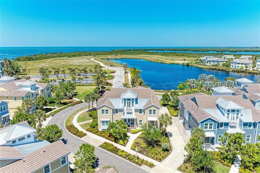Stunning like-new home, spectacular water views - Anna Maria Sound, Tampa Bay and Sapphire Lake - from every room in the house and all located in the incomparable, award-winning, gated, coastal resort community of Harbour Isle on Anna Maria Sound.  You can have it all in this Harbour Retreat model.  The home has 2781 sq. ft., three full bedrooms, three full baths, formal dining, kitchen with island and nook, sunroom, retreat, living/great room, Den, grand foyer, large two car garage, personal elevator going to all three floors and three outdoor spaces for enjoyment.  This luxury home is perfection, has upgrades and custom features galore and is move in ready.  It is impeccable decorated, and the furnishings are negotiable. To name just a few of the upgrades: new HVAC system in 2026 with 10 year warranty, epoxy garage flooring, new LG washer and dryer and laundry cabinetry, fresh interior paint, hot water heater, whole house water filtration system, custom window and door treatments, designer ceiling fans, custom wood work-featuring wide-plank Shiplap in vaulted living room ceiling, accent wall and tray ceiling in bedroom, home security system and incredible designer lighting in entryway, kitchen, dining room, kitchen pendants.  The kitchen features upgraded cabinets, pull-out shelving, new garbage disposal, tile backsplash, quartz countertops, wine refrigerator, GE stainless steel stove with dual ovens. The Owners’ suite is private and tranquil and the bath features dual vanities and luxurious walk-in shower. The guest bedroom has an en-suite bath, allowing for maximum privacy for your guests.  The home features a third spacious bedroom and an office/reading/music room.  The third full bath is located in the hallway and easily accessible from the main living area. This home has engineered hardwood flooring in living areas, tile in baths, Florentine Carrara tile in sunroom and upgraded Shaw anti-allergy carpet in bedrooms. The homes’ light and spacious feel are something to truly enjoy. The convenient location of this home, which is located next to the Harbour Isle Beach Club, puts the majority of the communities amenities at your fingertips. The building has block construction with Hardie board exterior siding and PGT impact rated windows. This home is beautiful coastal living at its best. All of Harbour Isle’s fabulous amenities are there for your enjoyment—including two miles of walking trails with inviting hammocks along the way. The 23,000 sq. ft. Beach Club overlooking Anna Maria Sound is all yours to enjoy. Explore the Beach Club area at the heated resort pool, spa, yoga lawn, beach to launch kayaks into the Sound, and the 4,200 sq. ft. fitness center. A calendar of lifestyle events are provided for you to enjoy. There are four pools for your use in Harbour Isle with cabanas, grills, fire pit, splash pad and playground. Just outside the gates of the community is Safe Harbor Marina, Floridays Restaurant and Compass Hotel. This gorgeous home is just a little over a mile from the sugar sand beaches and island charm of Anna Maria Island and less than two miles from Robinson Preserve with miles of walking, biking and kayaking. Live everyday like you’re on vacation in award-winning Harbour Isle.  It is truly paradise and can be all yours!